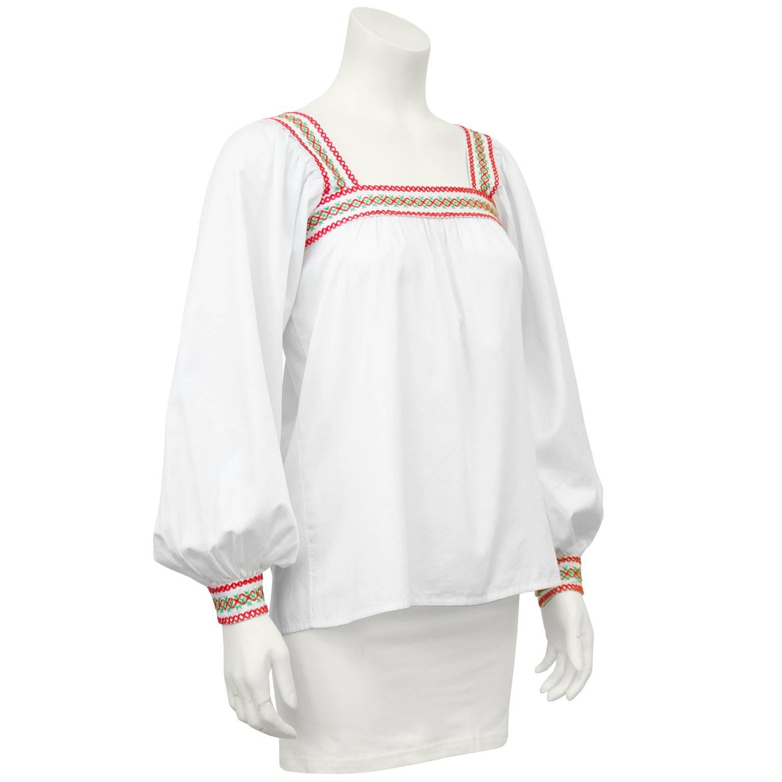 YSL white cotton peasant style top accented at the neckline and cuffs with hand stitched smocking. Dating from the late 1970s this is a great example of the famous peasant collection that is now regarded as one of  Saint Laurent’s most desirable. In