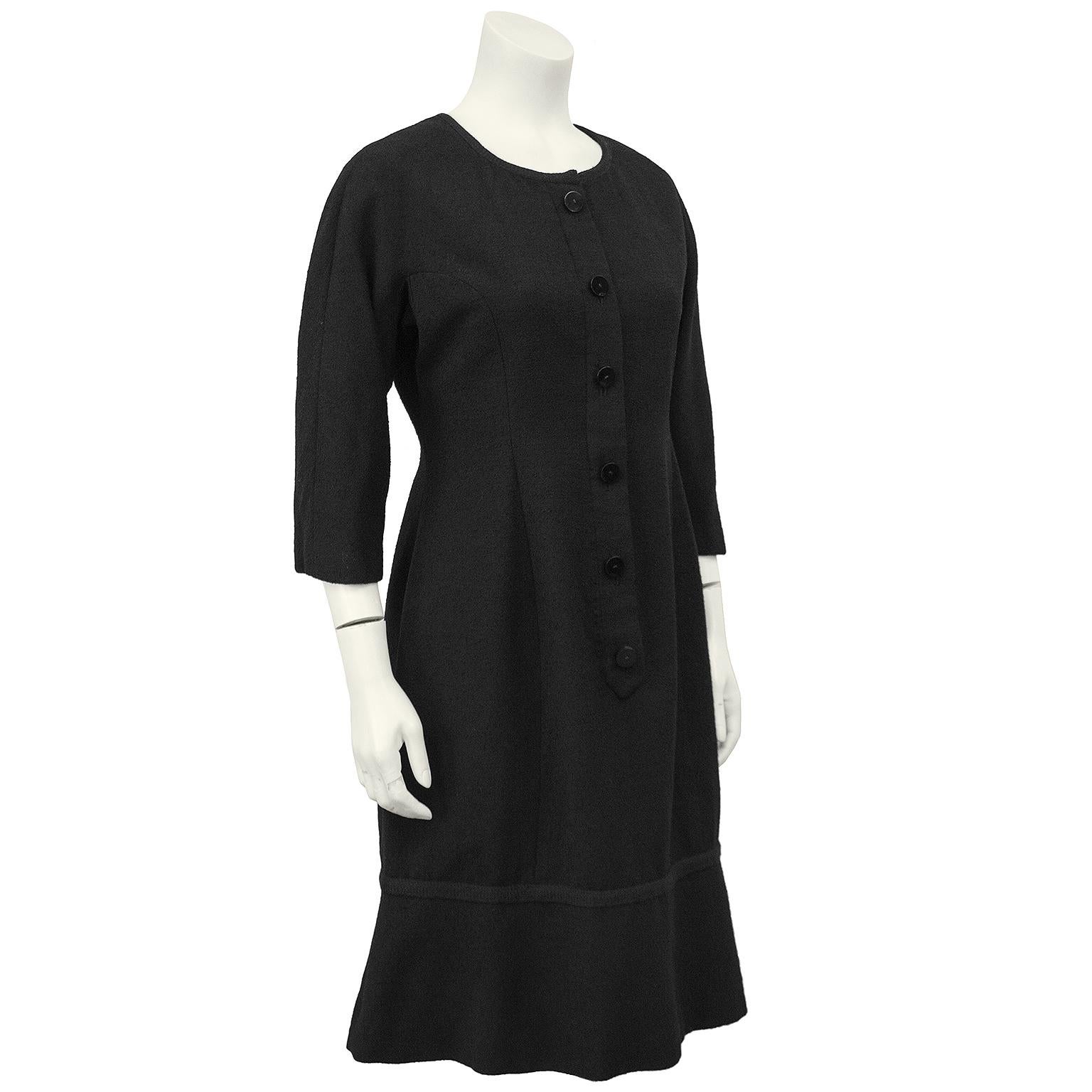 This Hattie Carnegie 1950s boucle wool black long sleeve day dress is elegant and sophisticated. Round neckline with long sleeves that hit just above the wrist, hidden zipper placket up the front with faux buttons made this dress easy to wear.