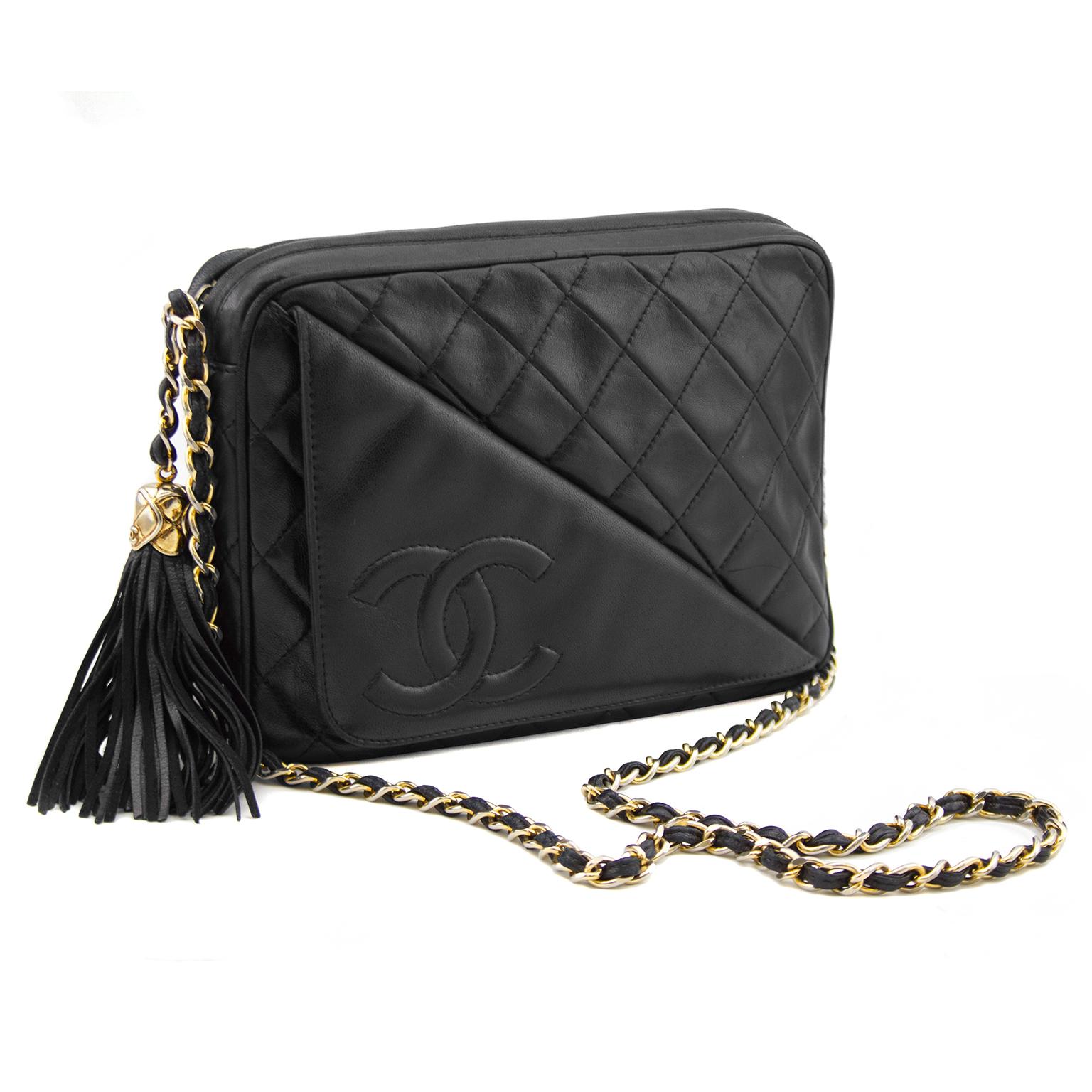 Finely crafted of luxurious diamond quilted lambskin leather, this shoulder bag from Chanel features a gold tone braided single chain link shoulder strap, a leather tassel embellished zip closure at top, exterior slip pocket featuring fold-over CC