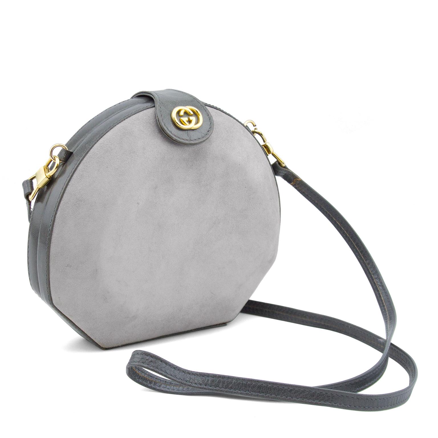 Unique 80s grey clamshell bag with a wonderful mix of finely grained leather and soft suede textures. Small top flap with GG medallion and snap covers the hinge frame which opens wide to reveal an black leather lining with stamped house signature.
