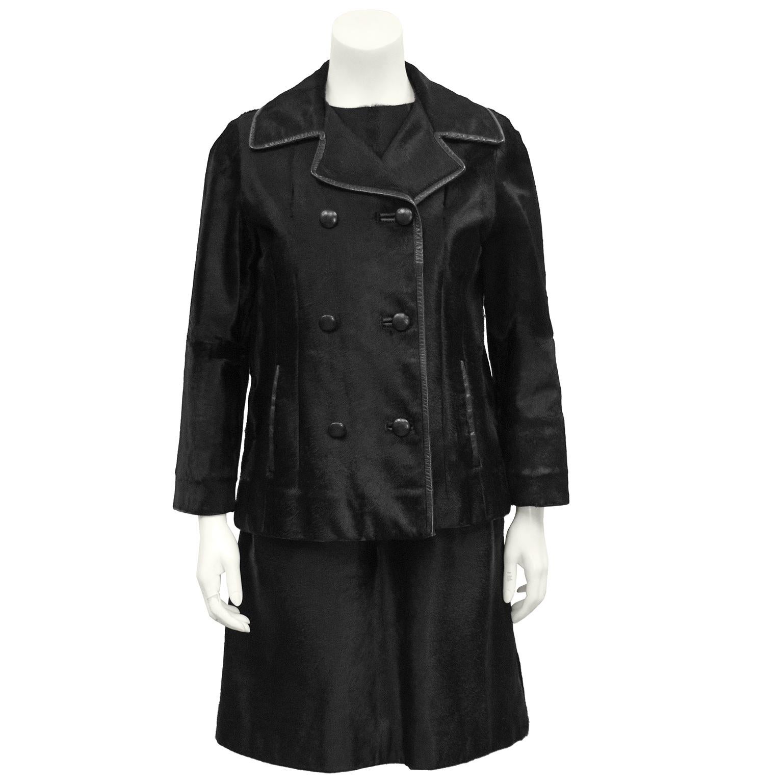 The classic dress and jacket with a twist. The sleeveless box fit shift dress has seams down the front and two front pockets. The matching Pea style jacket is double breasted with leather trim and side slit pockets. Bracelet length sleeves, in