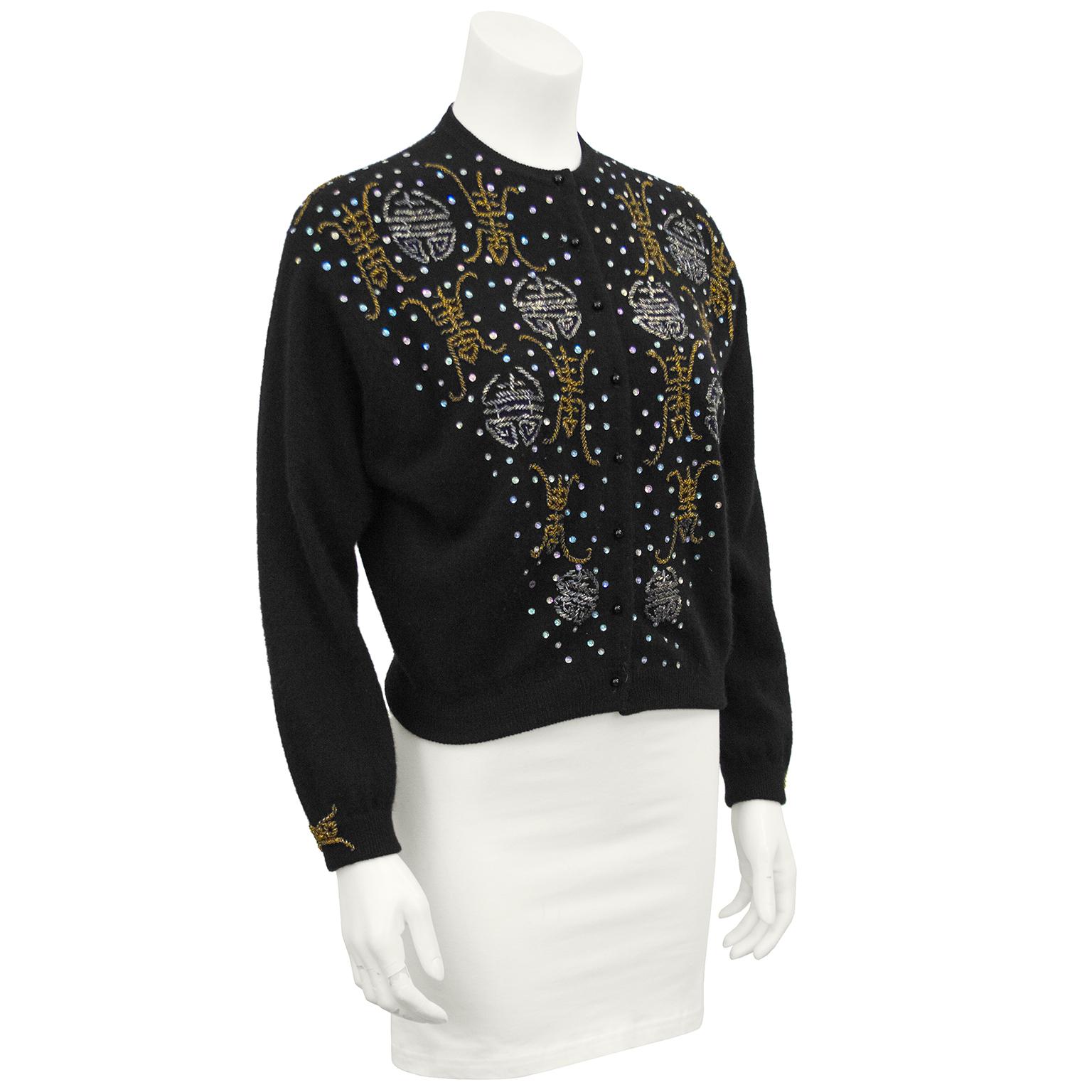 Elise Tu Hong Kong label black beaded cashmere sweater from the 1950s. Decorated down the front, along the back of the neck and on the cuffs with silver and gold beads resembling Chinese characters. Flat iridescent sequins scattered throughout. In