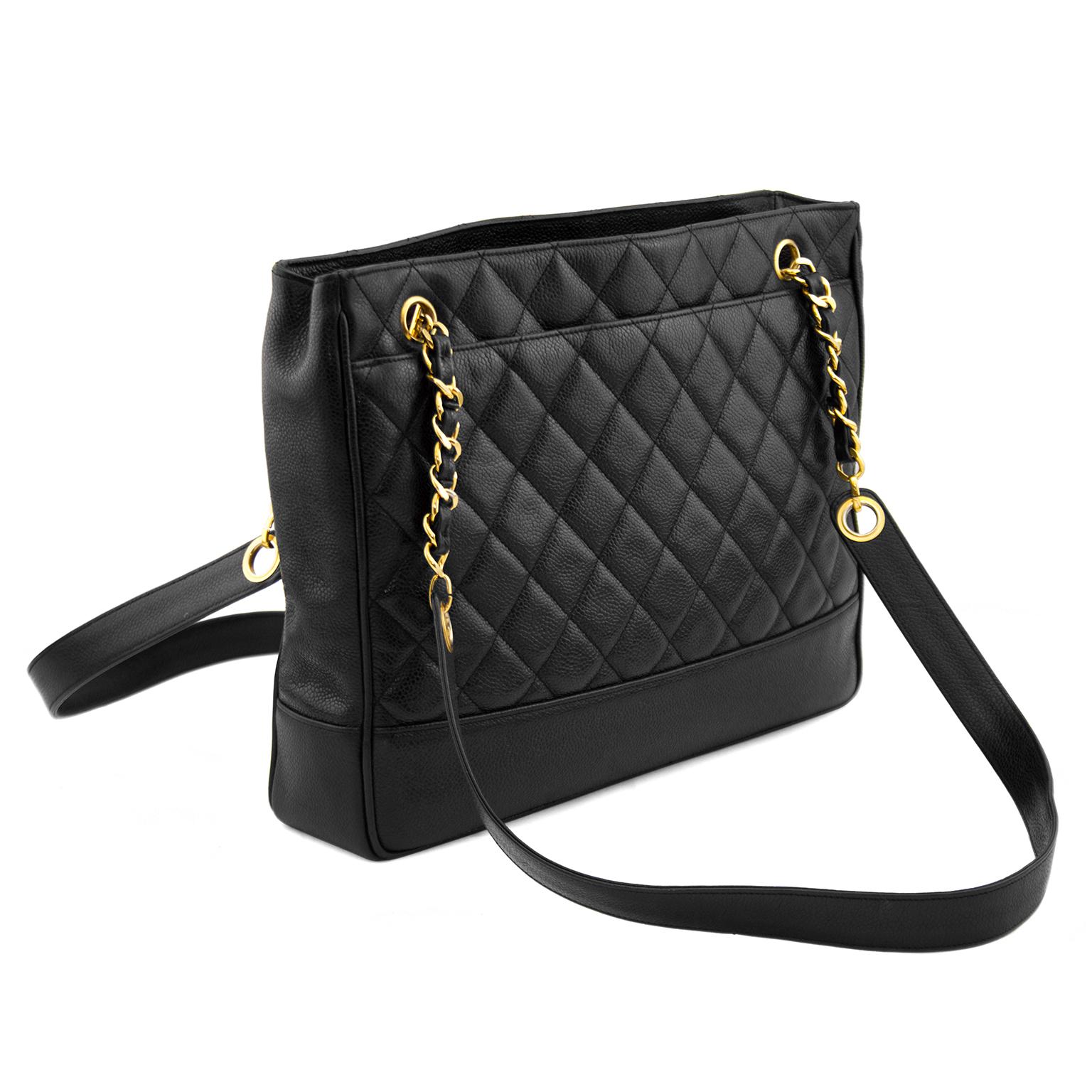 A bag that never goes out of style, Chanel black caviar leather shoulder bag with double straps and exterior pockets. The solid leather shoulder straps have gold chain and leather sections at the base that toggle into grommets at the top of the bag.