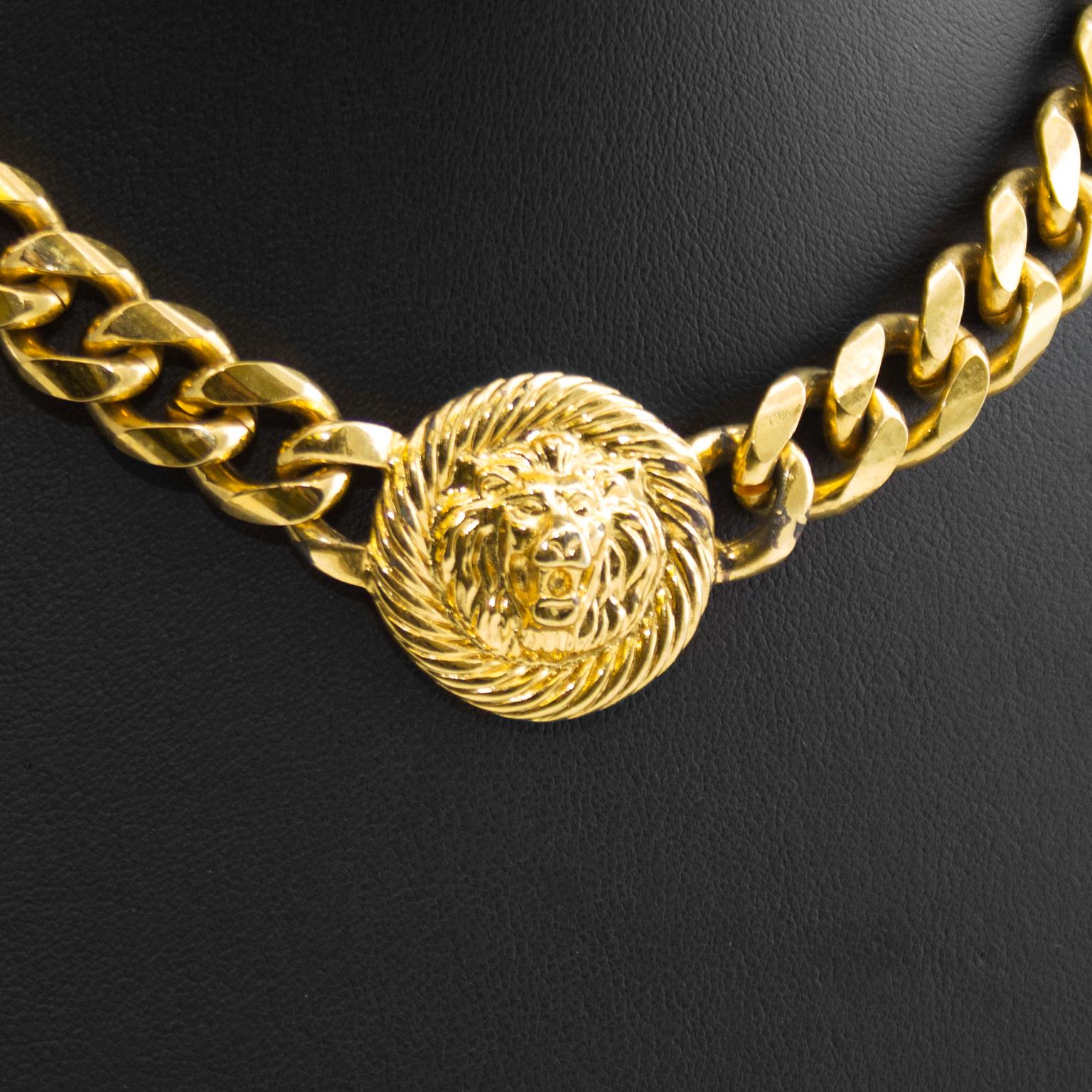 Anne Klein cuban link choker necklace from the 1980s. Center coin medallion has the iconic Anne Klein lion's head motif on it and the necklace closes with a toggle at the nape of the neck. In very good condition with some minor loss off gold plating