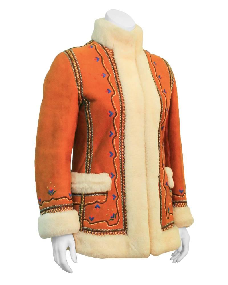 Winter warm 1970's tan sheepskin shearling fur coat by San Francisco manufacturer Furs by Max. Beautiful embroidery throughout the front and seams of coat. Coat hits right below the hips. Invisible hook and eye closures at neck and bust. Luxe hippy