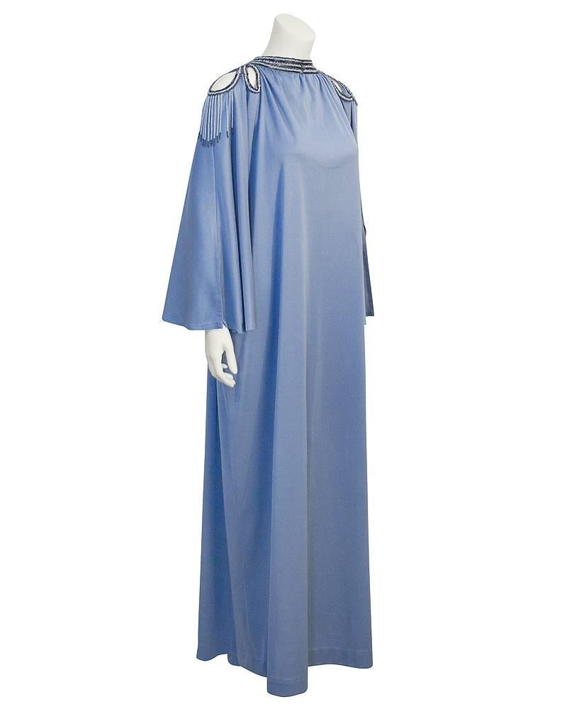 Early 1970's sky blue draped poly jersey kaftan/maxi dress by UK designer Frank Usher. Three key hole cut outs at each shoulder, trimmed in stunning black and blue hand beading with baby blue and black beaded fringe. Very ethereal chic look.