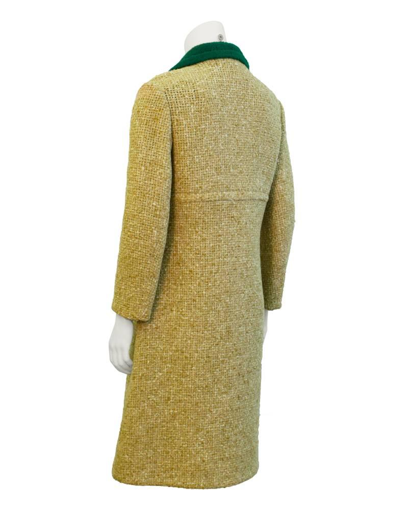 Tan woven wool single breasted day coat from the 1960's double sided with a striking kelly green felted wool collar and interior. Over sized horn buttons suggest the look of today. In very good vintage condition. Unique wool bonding technique