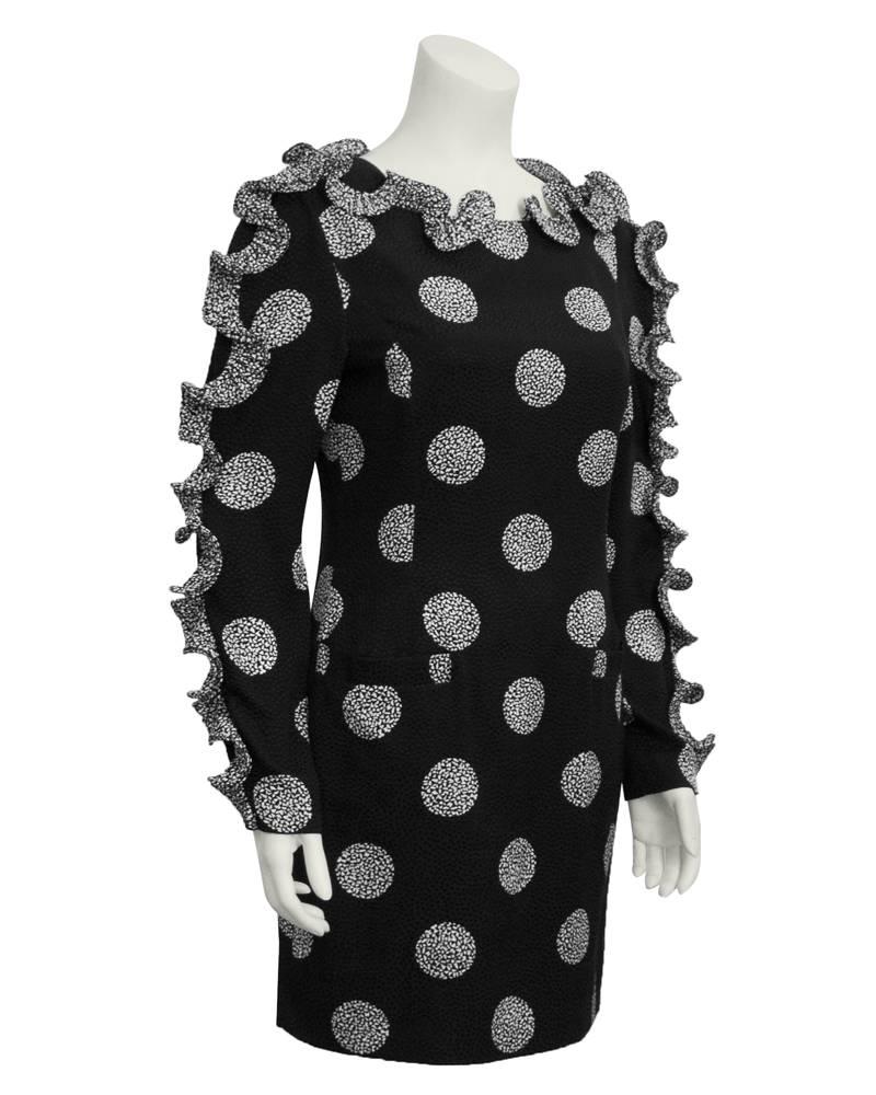 Fun and quirky 1980's Louis Feraud cocktail dress. Black silk jacquard with tiny black velvet polka dots and larger white polka dots made up of tiny white abstract speckles. Spiral ruffles all the way up the arms and across the neckline, in the same