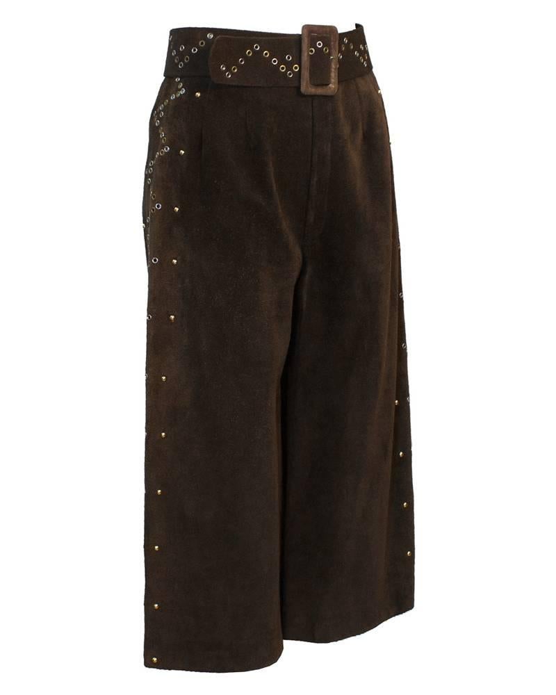 1970's Tiktiner brown suede cropped and flared culottes. These amazing on trend goucho pants are detailed with silver and gold grommets and gold domed studs down the sides of legs. Suede natural waist set belt with matching grommets throughout.