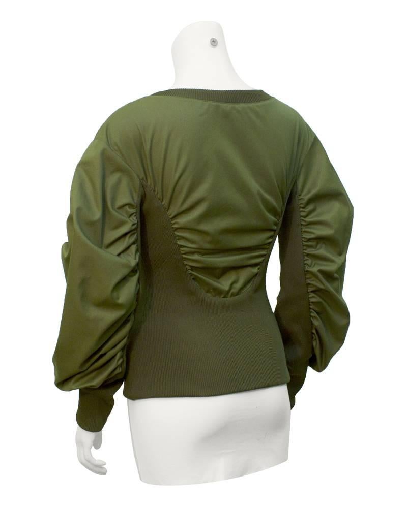 Cotton and polyester blend Alexander McQueen jacket from 2009. The bottom half of the jacket, the neckline and the cuffs are ribbed elasticized jersey. Where the elastic meets the rest of the jacket, the fabric is slightly gathered. Lots of volume