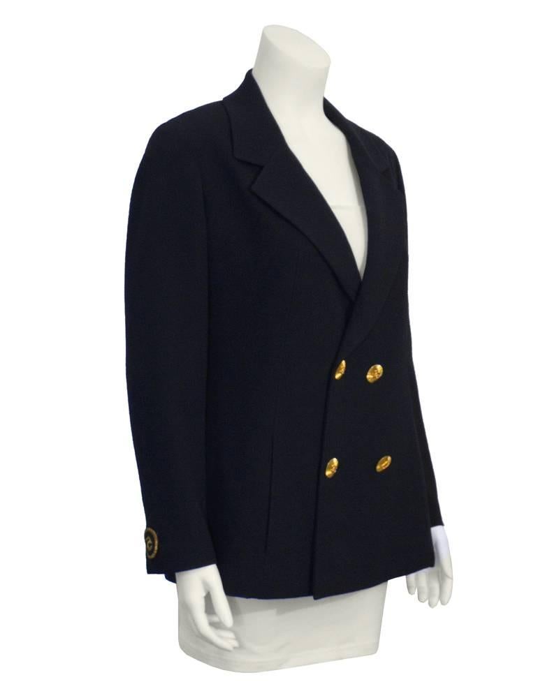 1990's Chanel double breasted navy blue wool gabardine blazer with stunning large gold Chanel logo buttons. Gold stitched Chanel CC logo on one cuff and the No. 5 logo on the other. Gold chain detail on inside. Great piece, excellent vintage