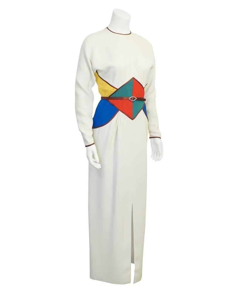 Amazing 1980's Geoffrey Beene long sleeve gown with brown trim and a matching brown satin optional belt with rhinestone buckle. Jewel tone geometric channel quilted details at waist with color block back and side panels. The primary colors really