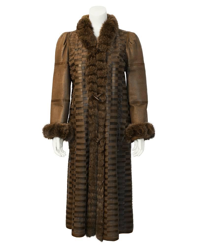 Chic 1980's unmarked Canadian brown mink reversible long coat. One side is brown leather patchwork pattern with a fur collar and cuffs. The textured pattern is created by piecing the buffed and natural finished unlined pelts in a stunning patchwork