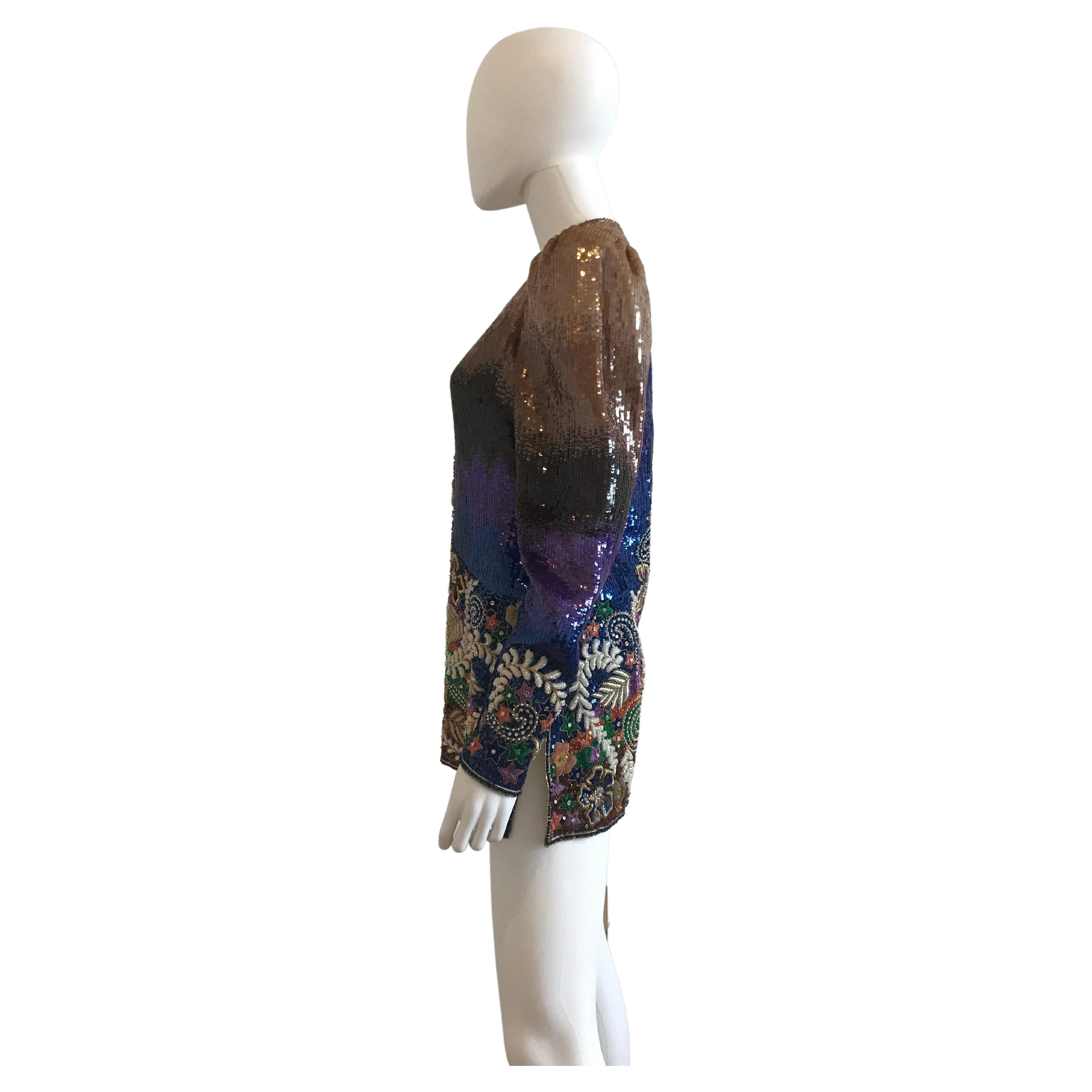 Mary McFadden Multi Color Sequins and Embroidered Top/Mini Dress
Star, branch floral embroidered motifs with rhinestones and pearl beading. Metal thread work. One side zipper on the side and one on the back. Zipper detailing on the sleeves allowing