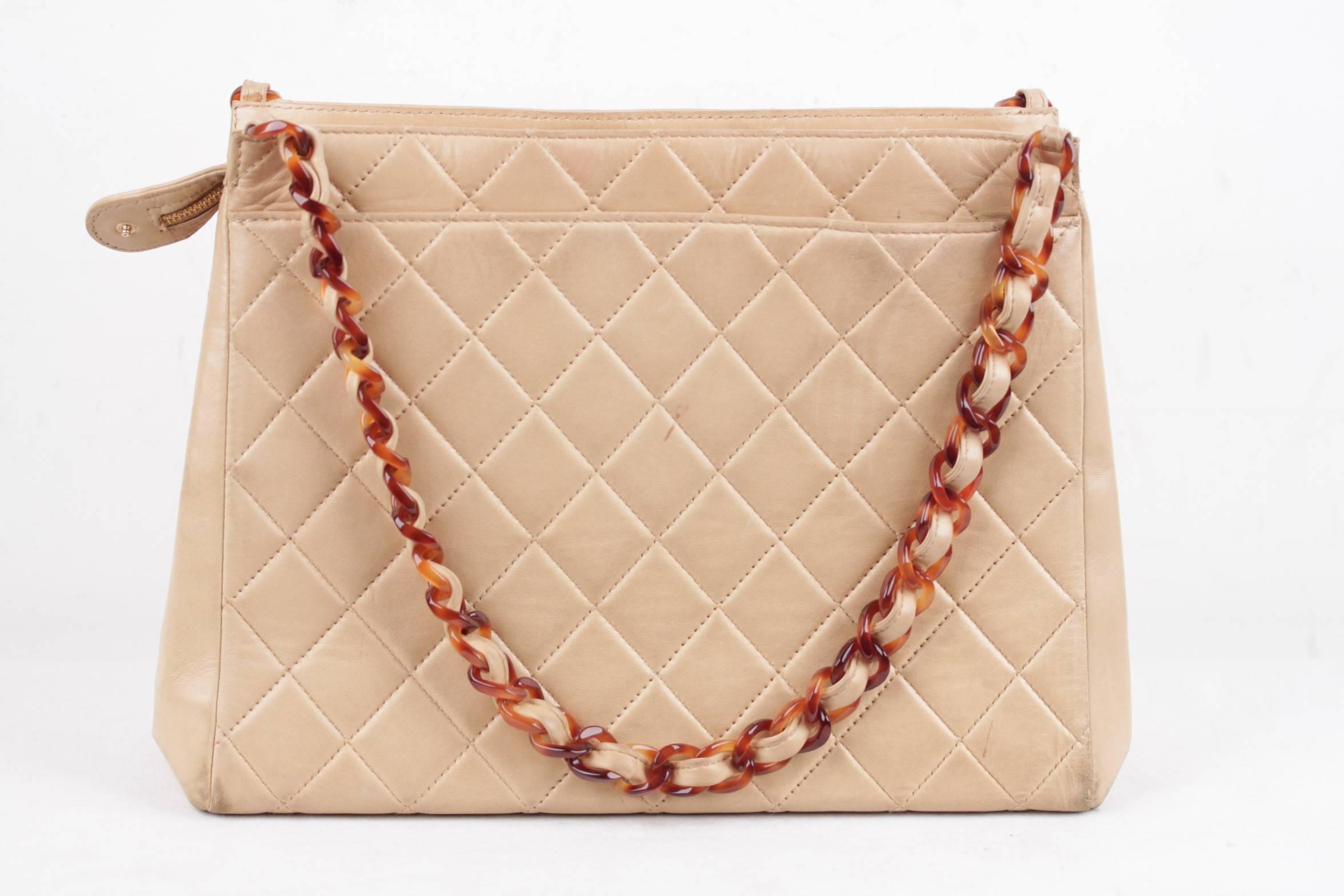  - CHANEL Vintage Tote in Tan Quilted Leather

- Tortoise chain link top handles threaded with leather

- Upper zipper closure

- Tortoise CHANEL zipper pull

- 1 open section on the front and 1 on the back

- Leather interior

- 1 side zip pocket &