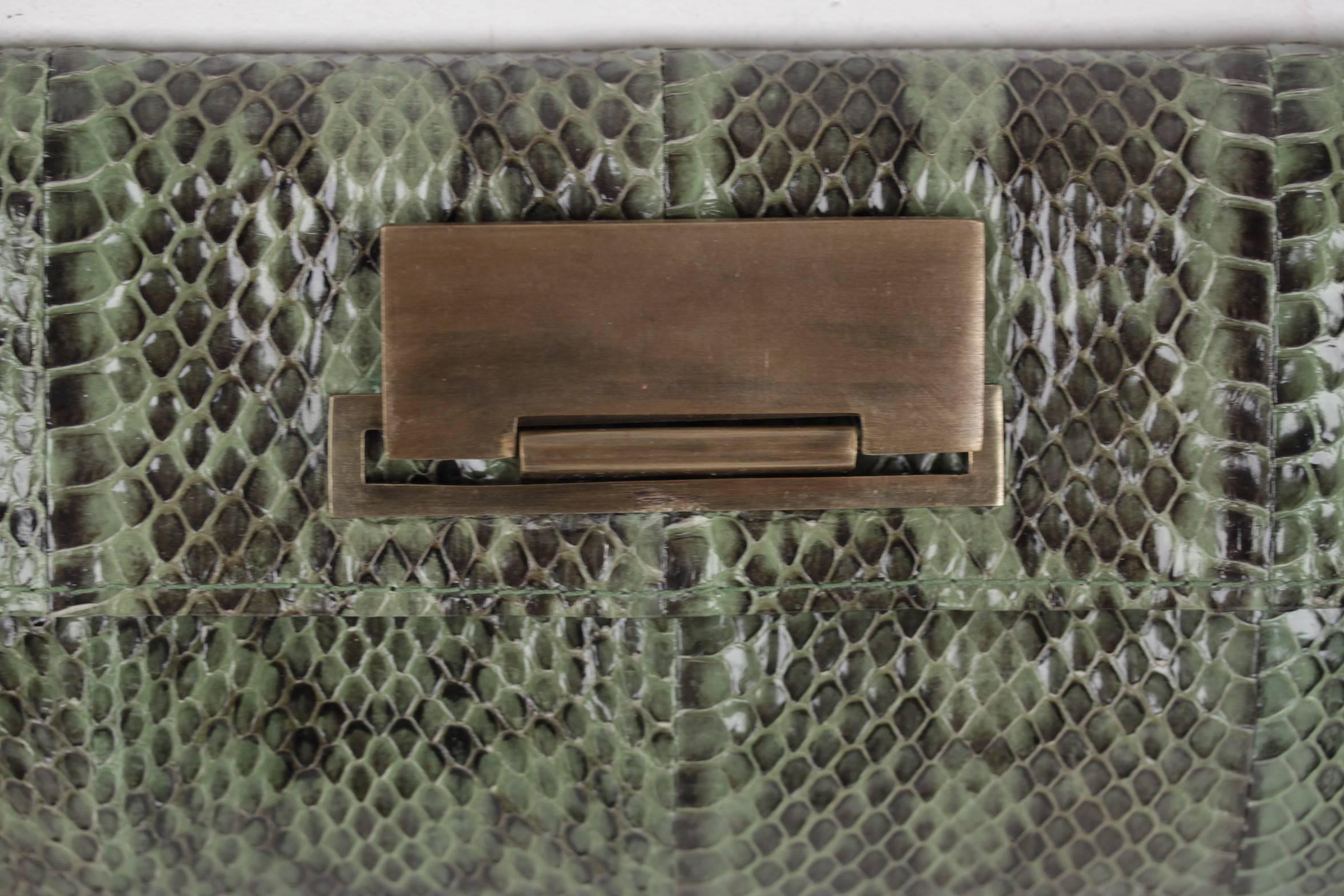  - Green python R & Y AUGOUSTI rectangular clutch

- Flao with clas closure on the front

- Green leather interior

- Brown fabric lining with designer signatures

- 1 side zip pockets inside

- Approx. measurements: 4 1/2 x 10 x 1 1/2