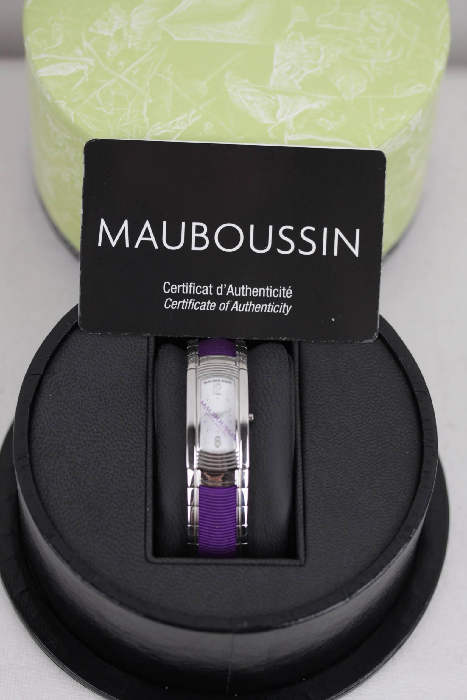  - Mauboussin rectangular stainless steel case with white dial
- Purchased in 2011
- Individual number: 1392 S
- Stainless steel bracelet with purple gros-grain fabric insert
- Quartz movement with battery
- Water resistance tested at 3AT
-
