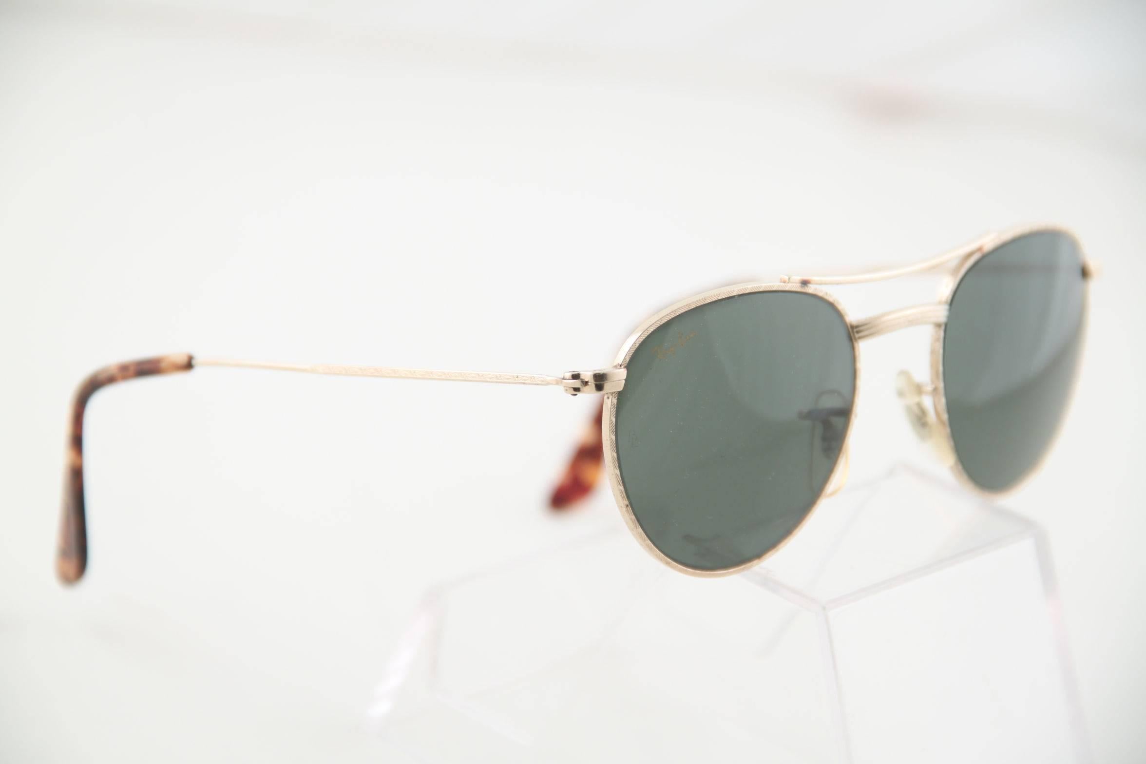  - Model: Ray Ban W 11754

- Cool variation of traditional aviator glasses

- Gold metal frame with original G15 lenses

- BL etched on each lens

- RAY BAN gold logo printed on RIGHT lens

- Come with a RAY BAN case

Any other detial which is not