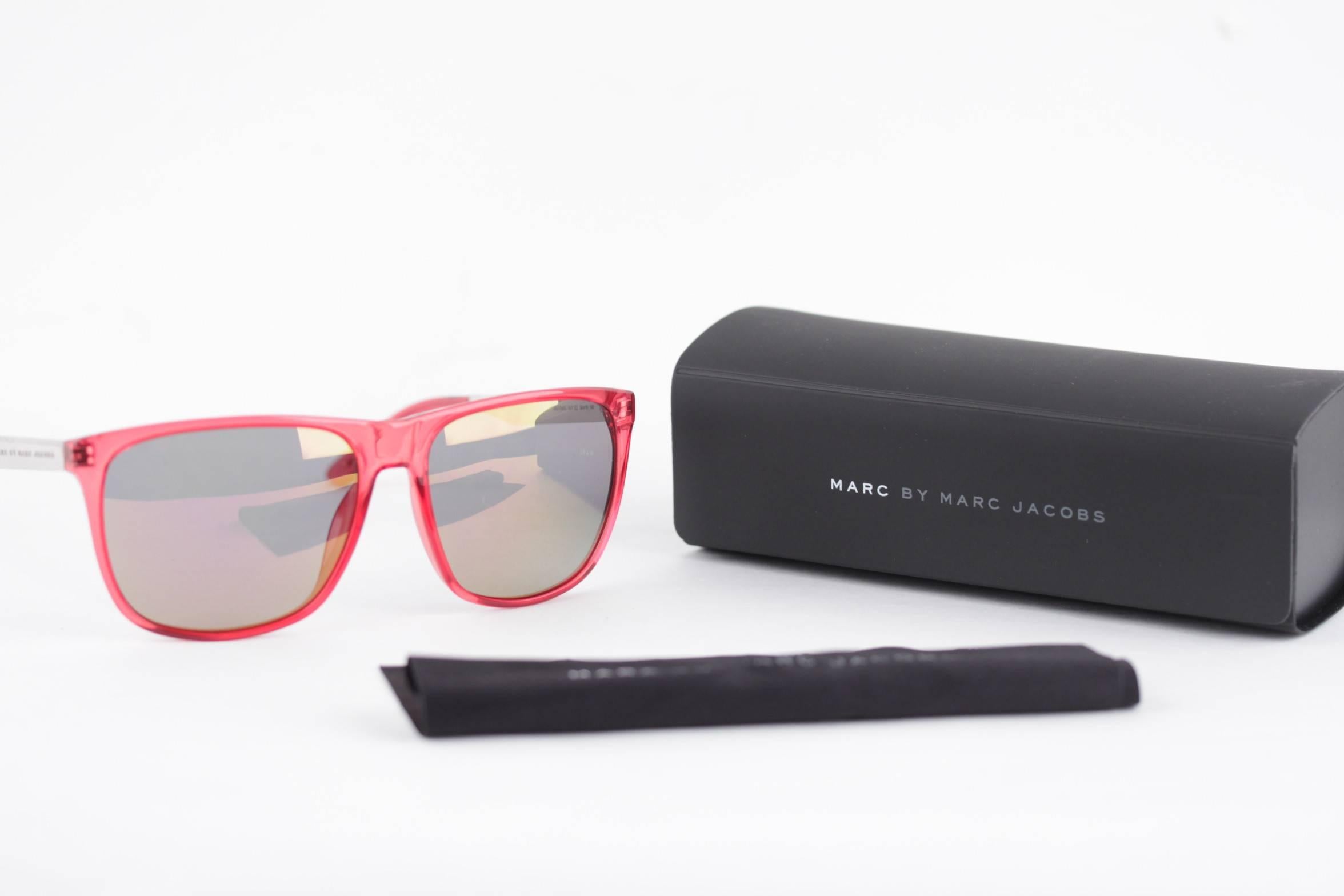 - Marc by Marc Jacobs MMJ 409S sunglasses
- Red semi-transparent plastic front and silver metal Temples
- Original half-mirrored 100% UV Protection lens
- 'Marc by Marc Jacobs' emobossed on the temple
- Original MARC by MARC JACOBS case and