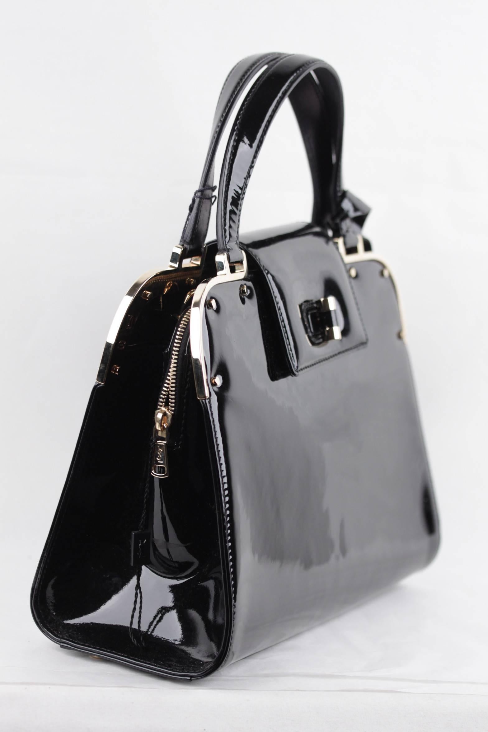 
- Yves Saint Laurent Black Patent Leather 'Uptown' Bag
- Features ultra-gloss black patent leather and gold metal hardware
- Double flat leather handles
- YSL's signature turn lock closure
- Black satin lining
- 2 Two open compartments & 1