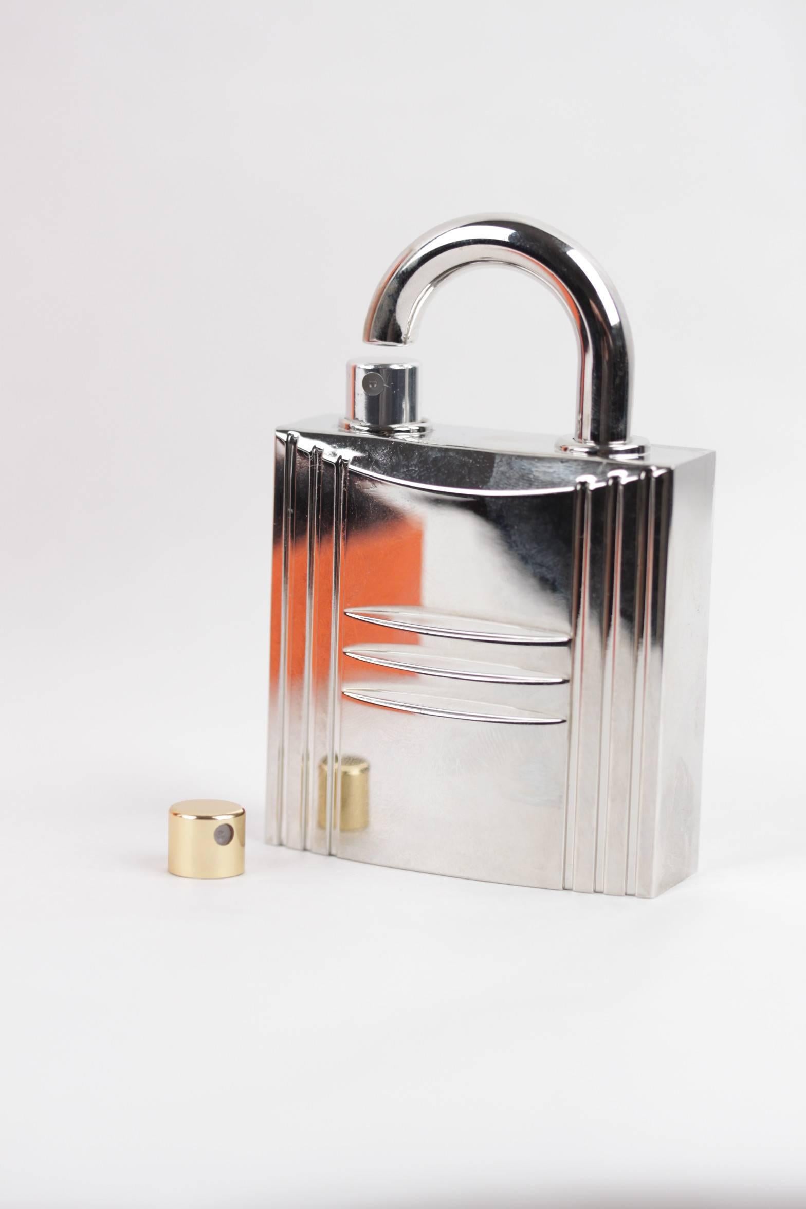  - Refillable silver & palladium plated 'Cadenas' jewel lock pure perfum spray bottle
- The bottle is crafted of shiny silver metal in the likeness of Hermes’ iconic padlock
- This smart silver padlock holds a '24 Faubourg' Pure perfume spary