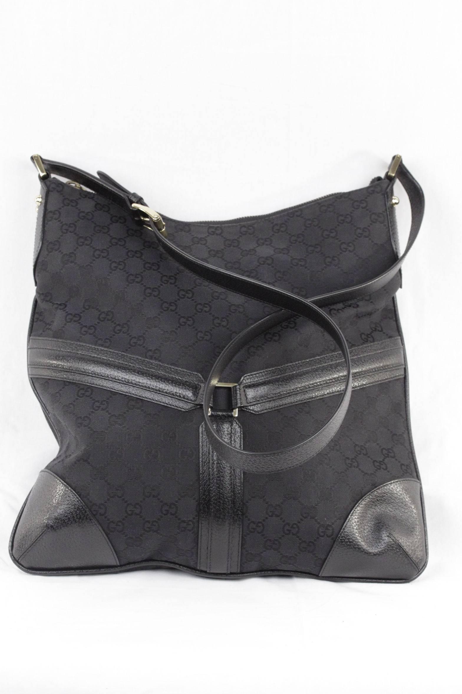  - Gold metal GG - GUCCI logo detail on the front
- Crafted in GG monogram canvas with leather trim
- Upper zipper closure
- Black canvas lining
- 1 side zip pocket inside
- Adjustable shoulder strap
- Approx. measurements: 16 x 15 1/2 x 2