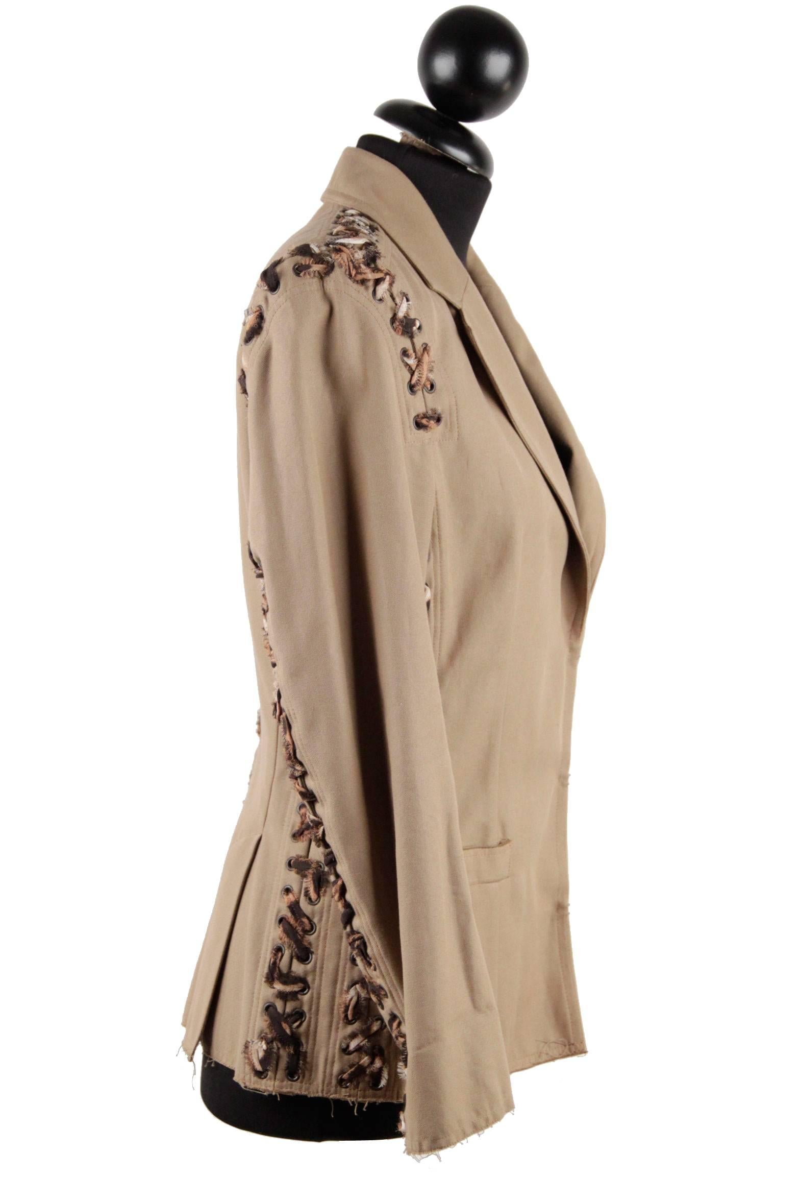 
- Fitted jacket
- Composition: 100% Cotton
- Color: Tan
- Long sleeves
- Notch lapel collar
- Hits around hips
- Animal print lace up detail
- Front welt pockets
- Padded shoulders
- Front hook-and-eye closure
- Unlined
- Size: 36 FR