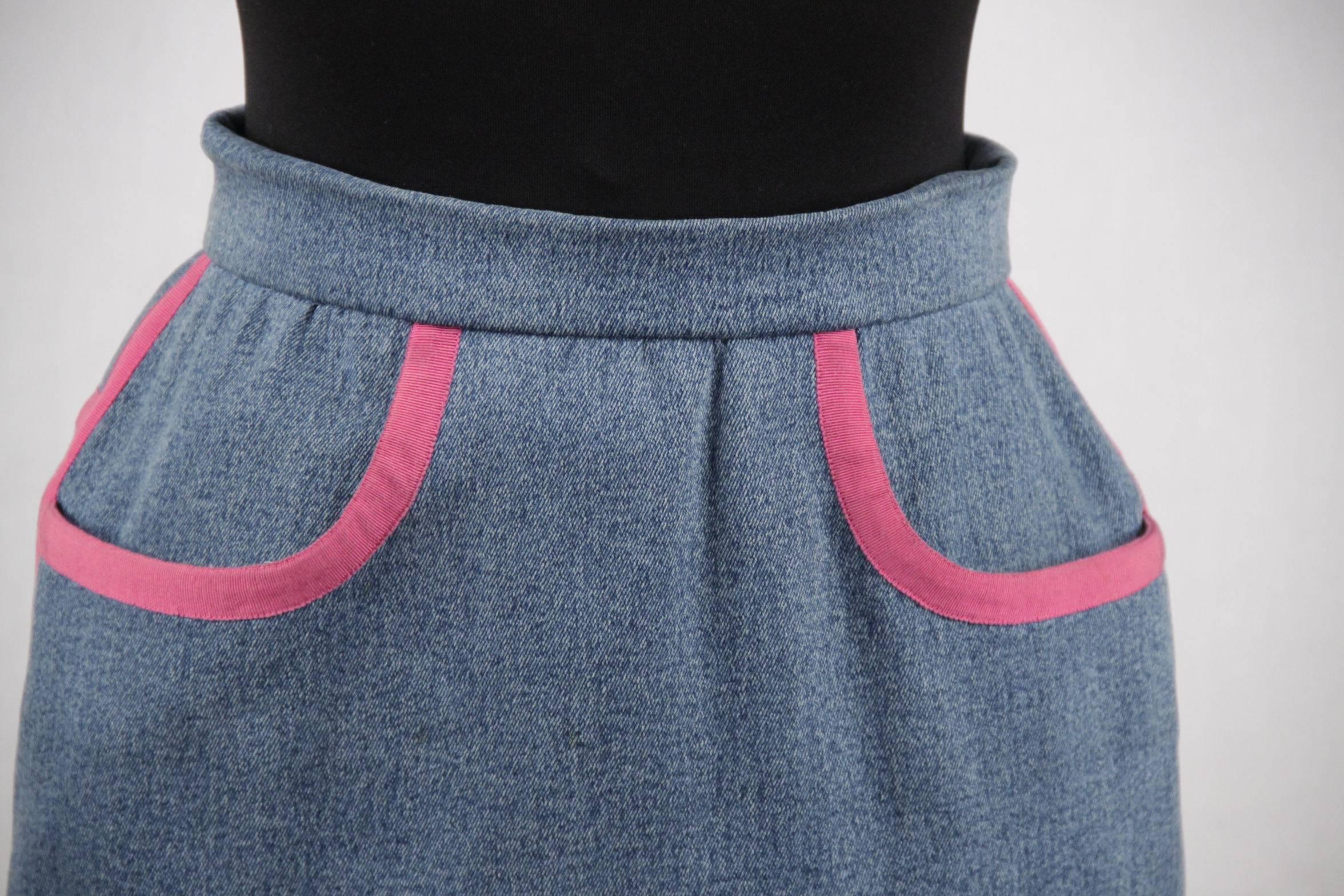  - Vintage denim pencil skirt by Chanel
- It is made of acid washed denim
- It is trimmed with bright pink grosgrain ribbon around the hem, the pockets and the back seams
- Stretch fabric
- Zip and hook closure on the back
- 2 pockets on the
