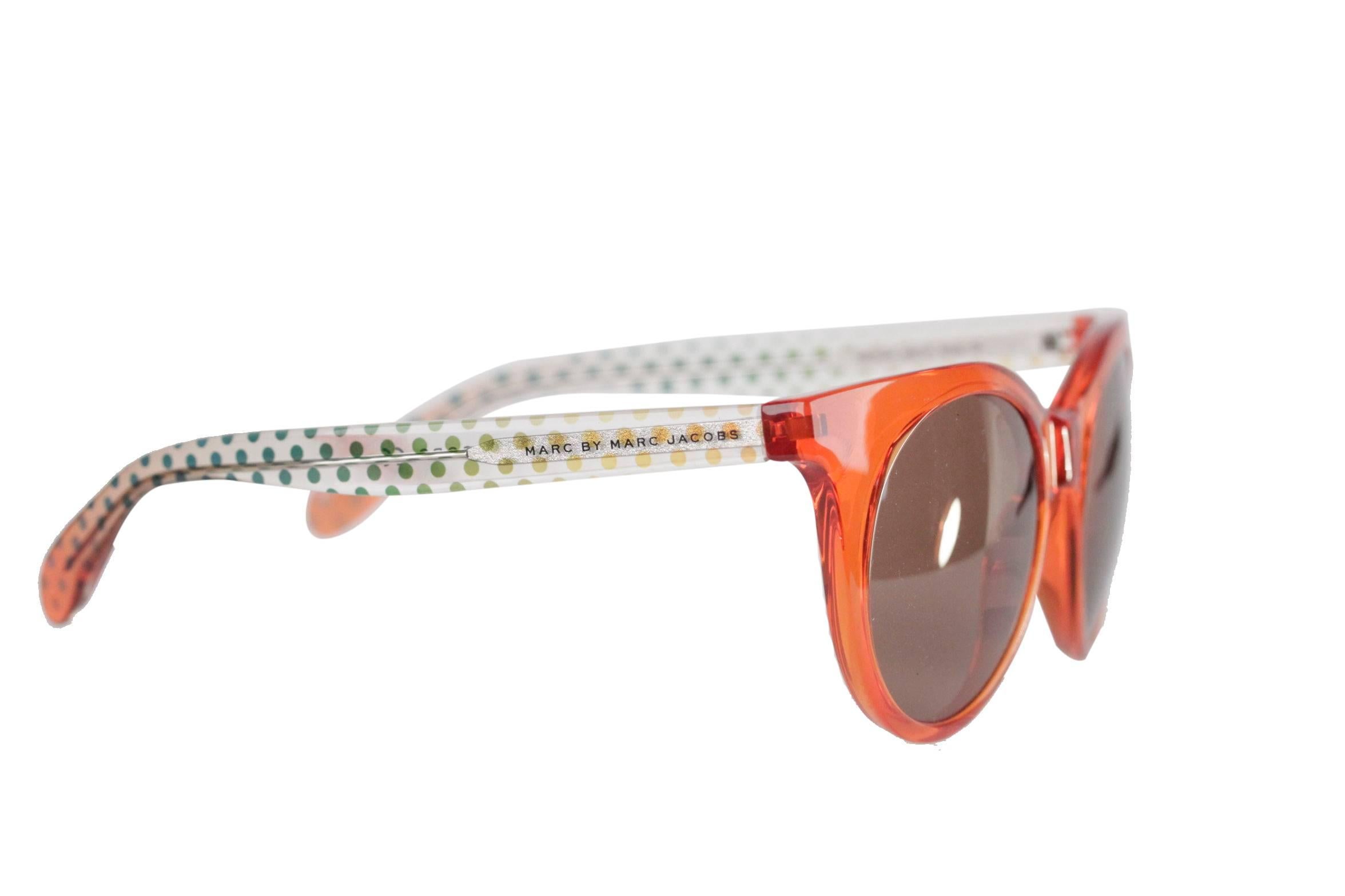  - Marc by Marc Jacobs MMJ 412/S sunglasses
- Orange plastic front and plastic transparent Temples with green polka dots pattern
- Brown lens
- 'Marc by Marc Jacobs' emobossed on the temple
- Original MARC by MARC JACOBS case and cleaning cloth