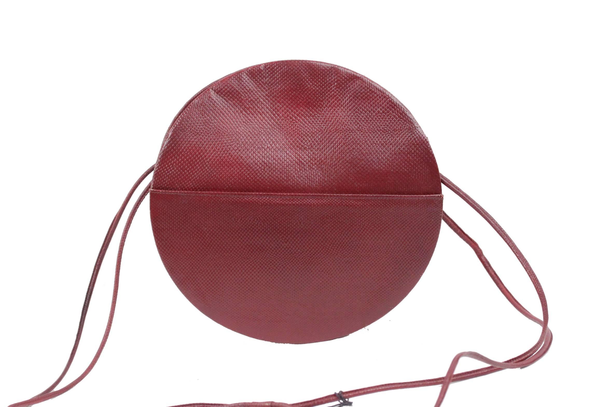  - Vintage Burgundy Shoulder Bag by ANDREA PFISTER
- Round shape
- 1 open pocket on the exterior on each side
- Upper magnetic button closure
- Gold tone lining
- 2 main sections with 1 side zip pocket & 1 side open pocket
- Approx.