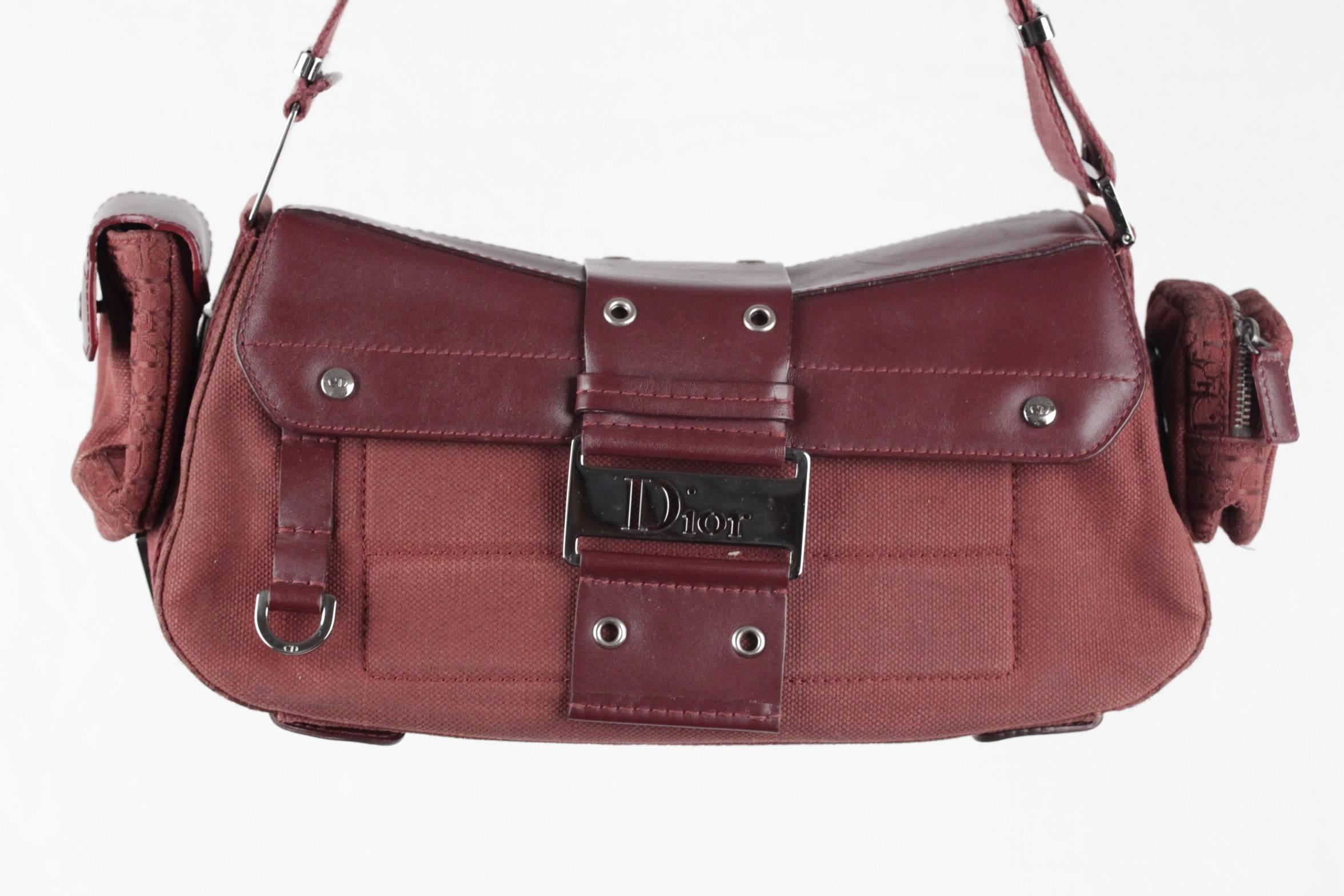  - Christian Dior Canvas 'Street Chic Columbus Avenue' Multipocket Bag, inspired by classic utility bags
- 4 detachable pouches to hold your cell phone and othersmall items (two with snap closures, two with zip closures)
- Burgundy structured