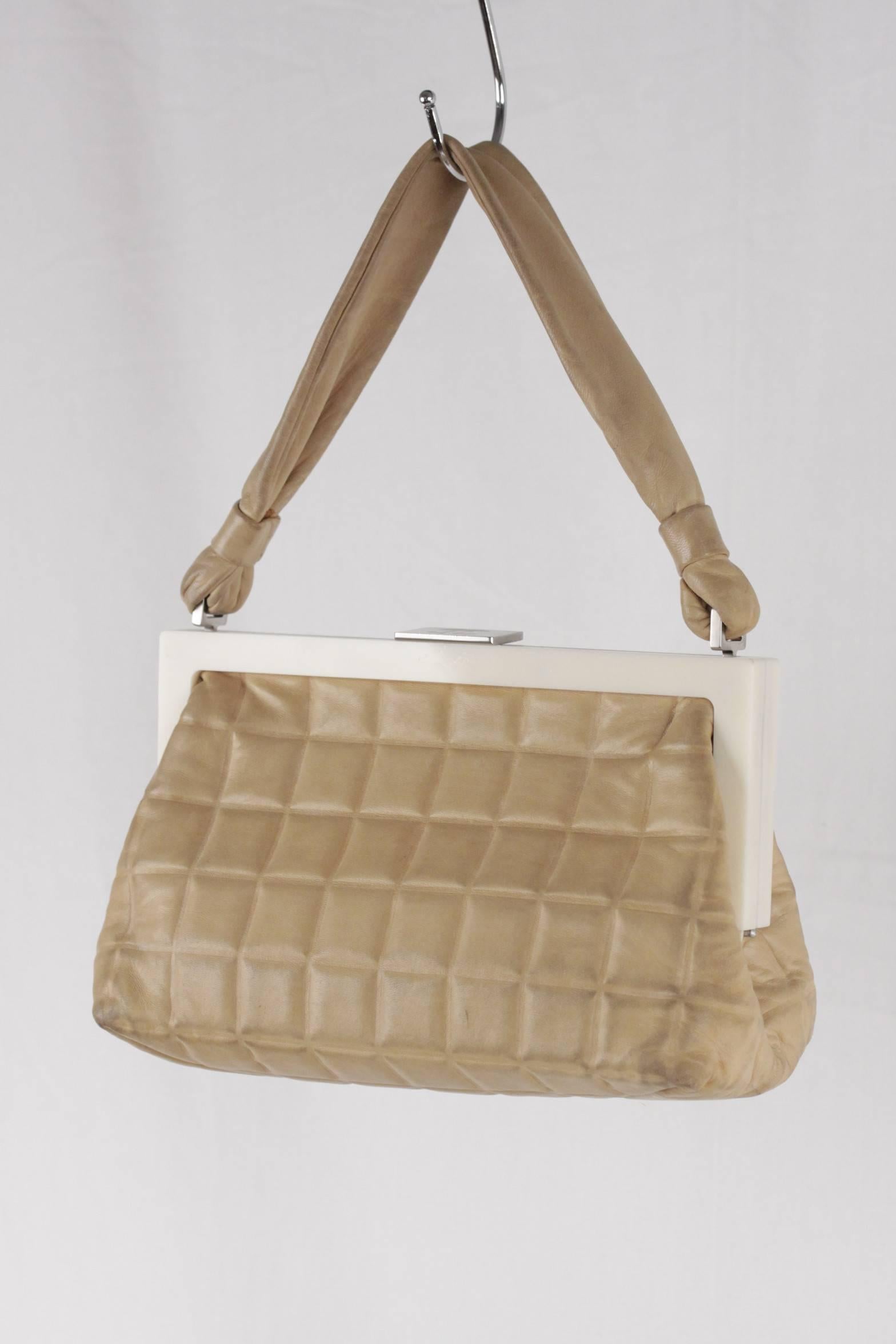  - CHANEL Vintage Handbag in Tan Quilted Leather

- White lucite frame

- Silver metal hardware

- Enamel CC - CHANEL logo on hardware

- Off-white leather lining

- Snap lock closure on top

- 1 side open pocket inside

- Approx.