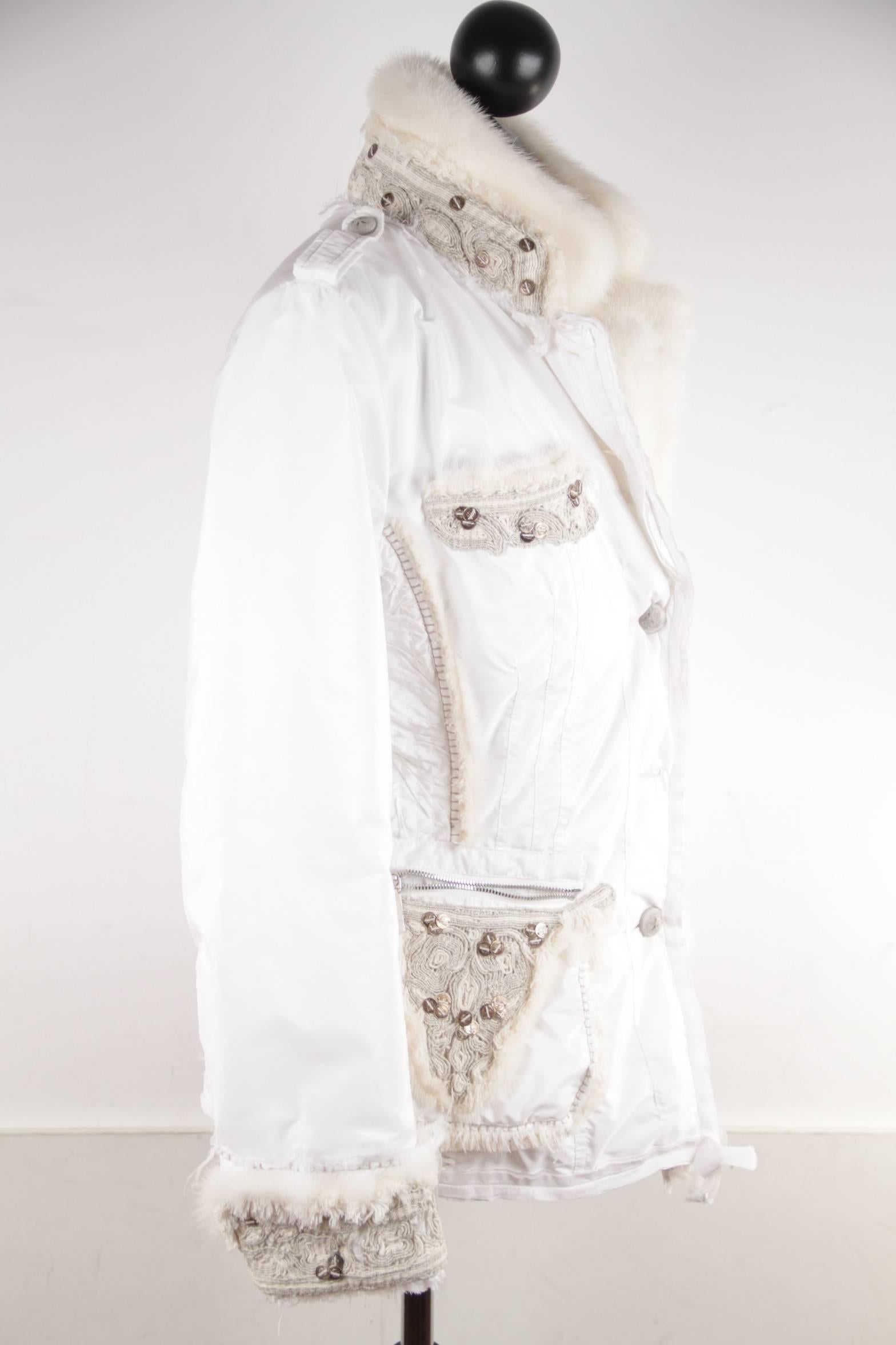 

- White color

- Mink fur trim

- Long sleeve styling with zipped cuffs

- Button closure on the front

- Fitted waist

- 2 zip pockets on the waist & 2 pockets on the chest

- Mink fur waist belt

- 2 extra-button included
-