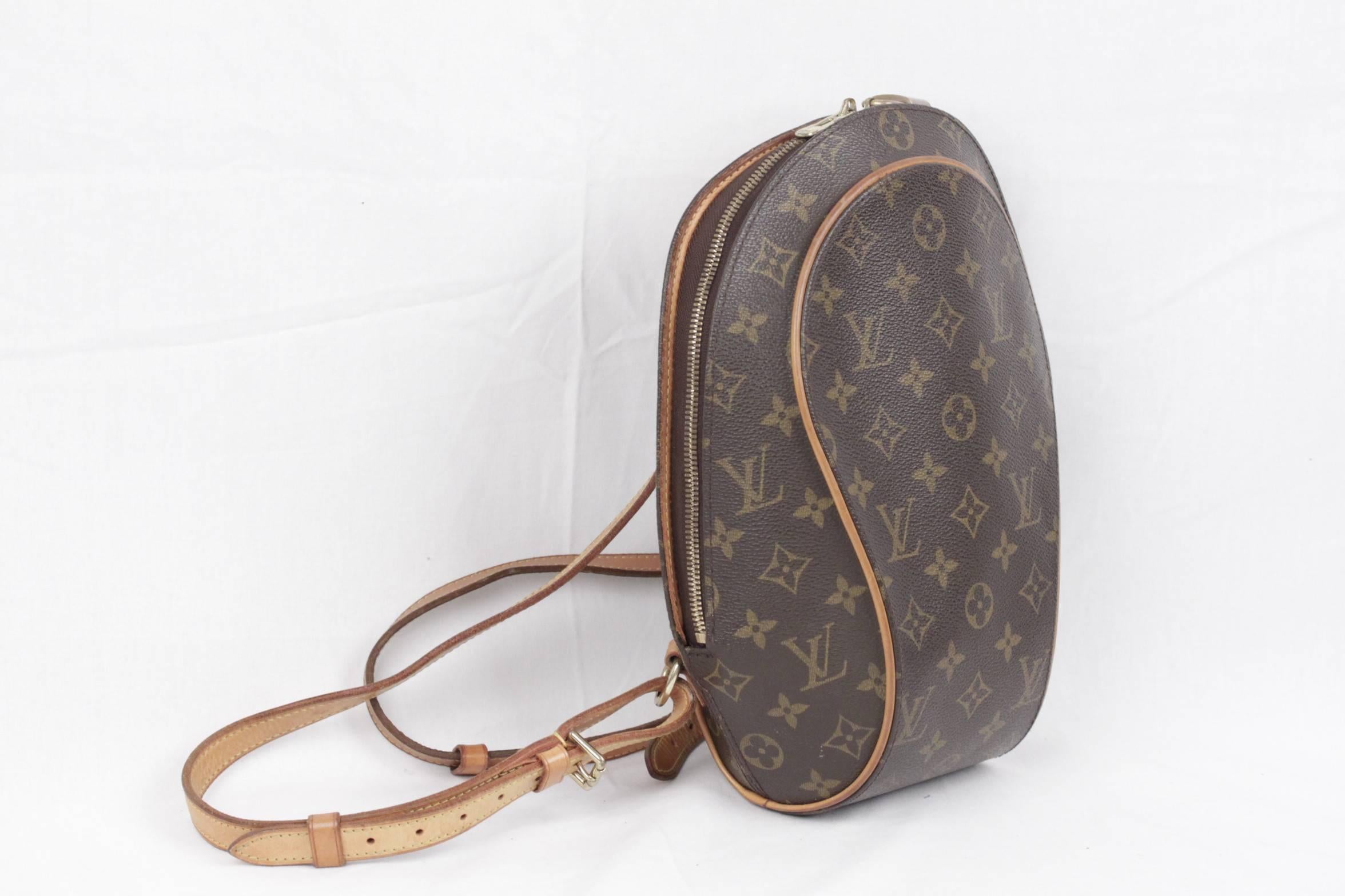  - Sophisticated Louis Vuitton 'ELLIPSE' Backpack bag
- Top is closed with double zipper
- Original Louis vuitton padlock with key included
- Long and adjustable shoulder straps with gold metal hardware
- Brown interior
- 1 open pocket and