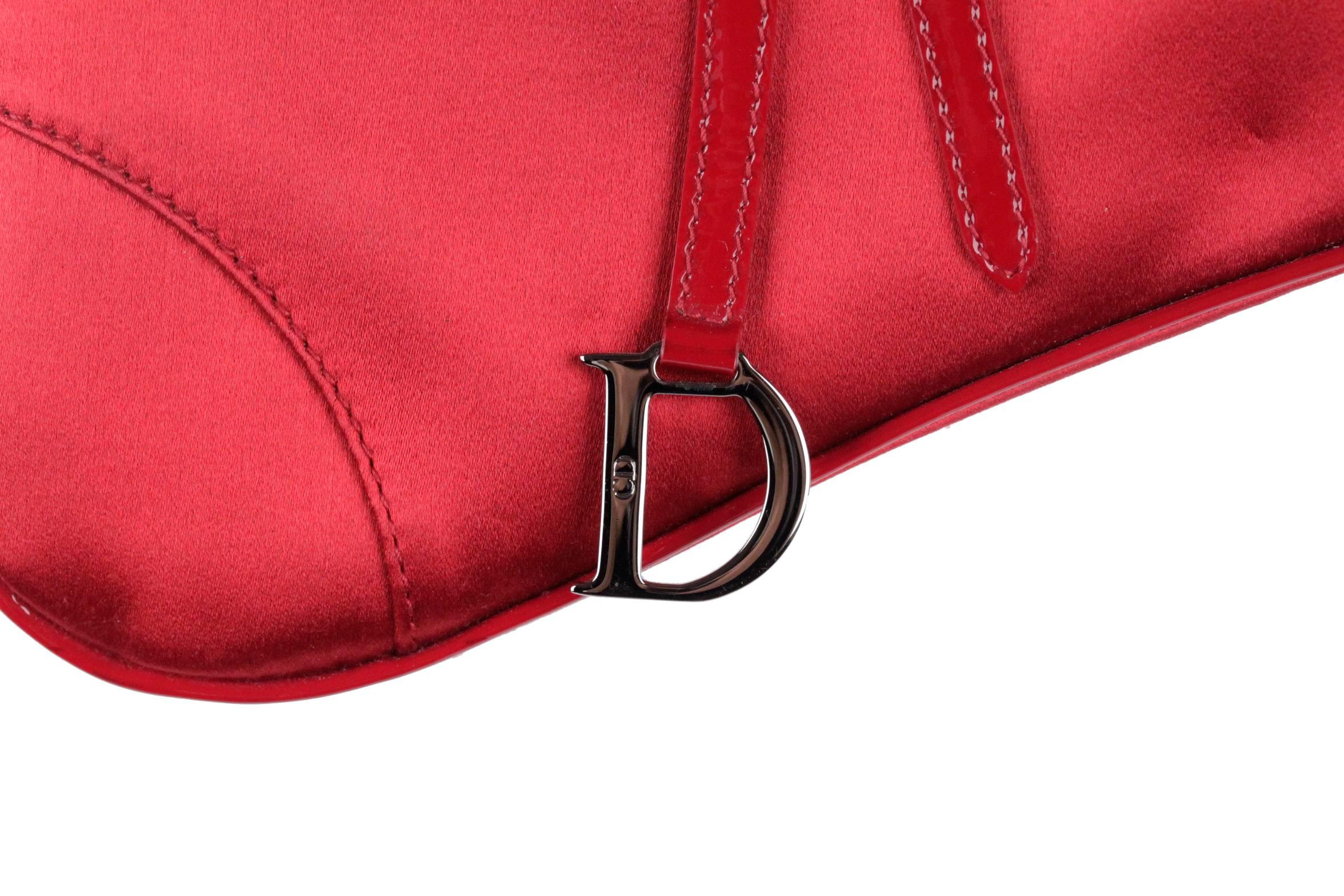  - Christian Dior Mini Evening Saddle Bag in red satin
- Really lovely and unique, perfect for special evenings or black tie affairs
- Silver framed opening
- Push lock at side
- Trimmed with black patent leather piping and details
- The single