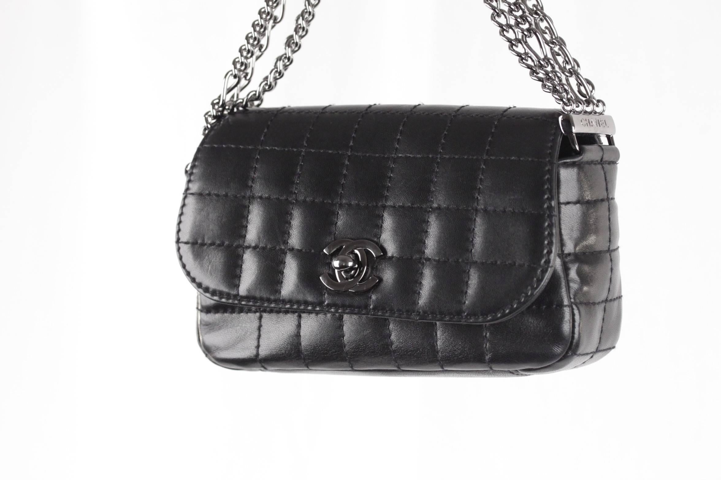  - Chanel Black Square Quilted Leather Chain Flap Bag
- Multi-chain handle
- Gunmetal CC - CHANEL logo twist closure
- Chanel signature fabric lining
- Measurements: 4 x 7 x 2 inches - 10,2 x 17,7 x 5,1 cm

Logos / Tags: 'CHANEL -Made in France'