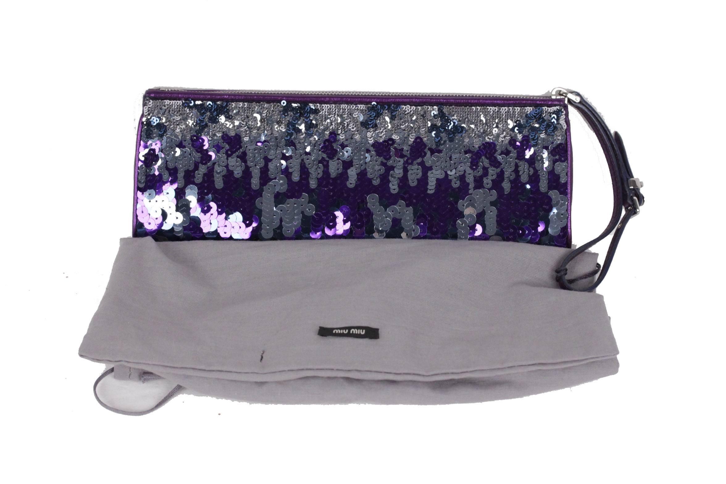  - Metallic purple leather Miu Miu wristlet
- Silver sequin embellishments throughout
- Silver-tone hardware
- Zip closure on top
- Purple satin lining
- Leather wristlet strap at top
- Includes dust bag
- Measurements: 4 x 10 1/4 x 1 1/4