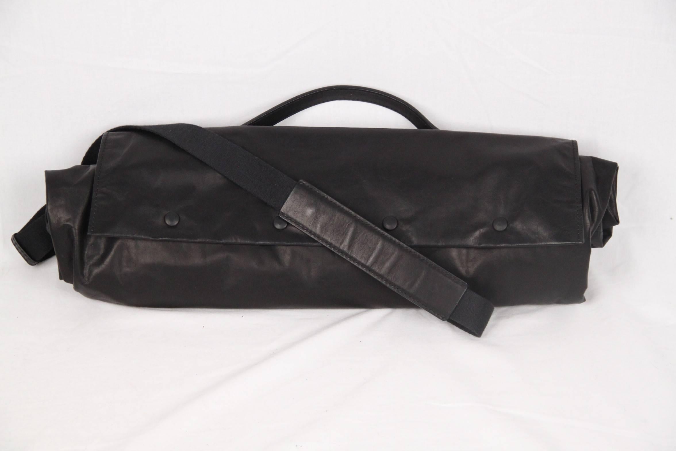 
- Made from black soft washed-leather
- Top handle and adjustable shoulder strap (drop: 17 1/2 inches - 44,5 cm)
- Back zipped pocket
- Silver and tonal hardware
- Snap fastenings 
- Fully lined in canvas
- 2 spacious compartments and 1 side