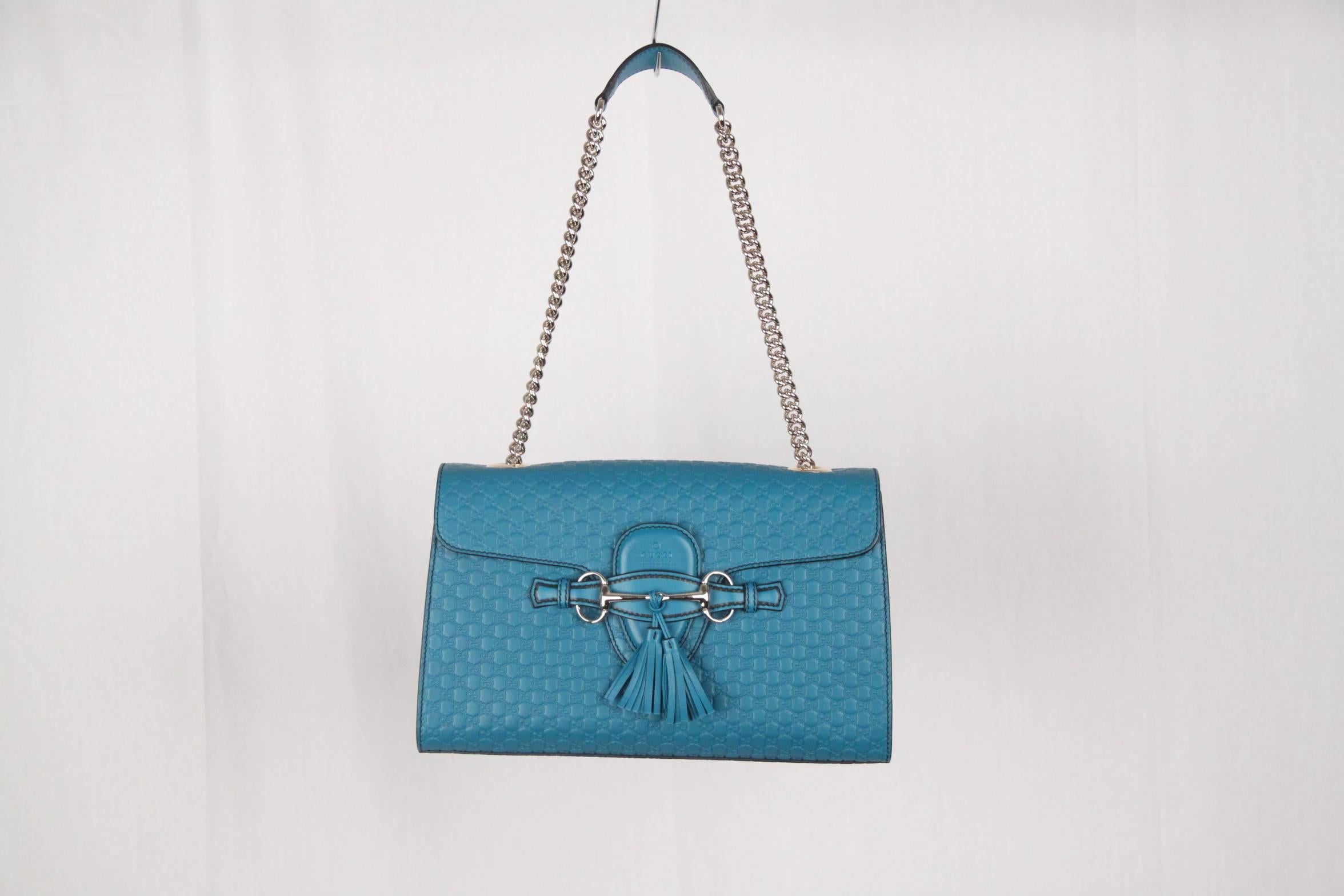 - Turquoise Microguccissima leather Gucci 'Emily' Chain shoulder bag 
- Silver-tone hardware
- Chain-link shoulder strap
- Horsebit & Tassels detail at front
- Ivory canvas interior lining
- 3 slit pockets at interior walls 
- Fold-in flap