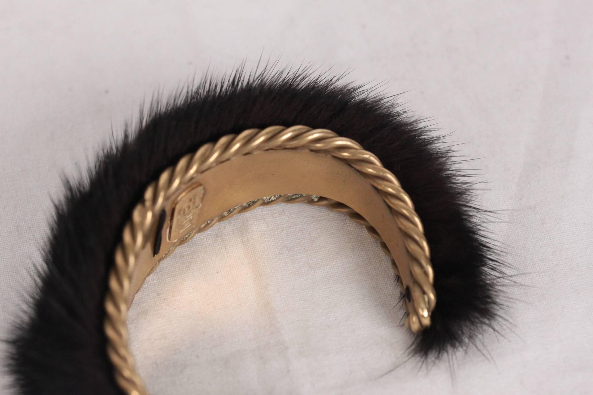 - Gold metal FENDI bracelet with fur top
- Color Black
- It will come with its original FENDI box
- Max. approx. internal diameter: 2.35 inches - 6,2 cm 
- Width: 1 inch - 2,5 cm 
 

Logos & Tags: 'FENDI - made in Italy' inside the