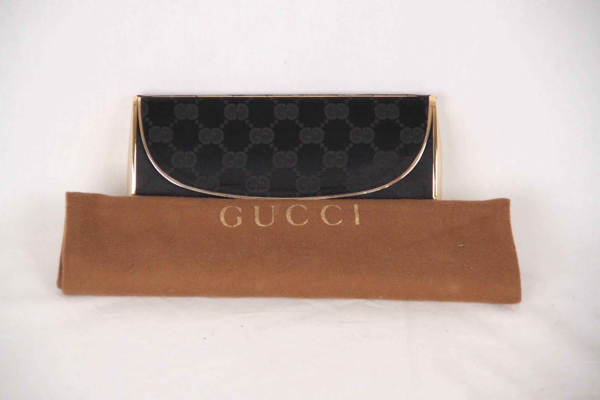 - Vintage gold metal box clutch by GUCCI
- Black GG - GUCCI monogram fabric covering 
- Flap closure
- A built-in mirror on the reverse of the metal flap
- The purse is lined in a velvet-like fabric
- Measurements: 3 1/2 x 7 1/4 x 1 3/4 nches - 8,9