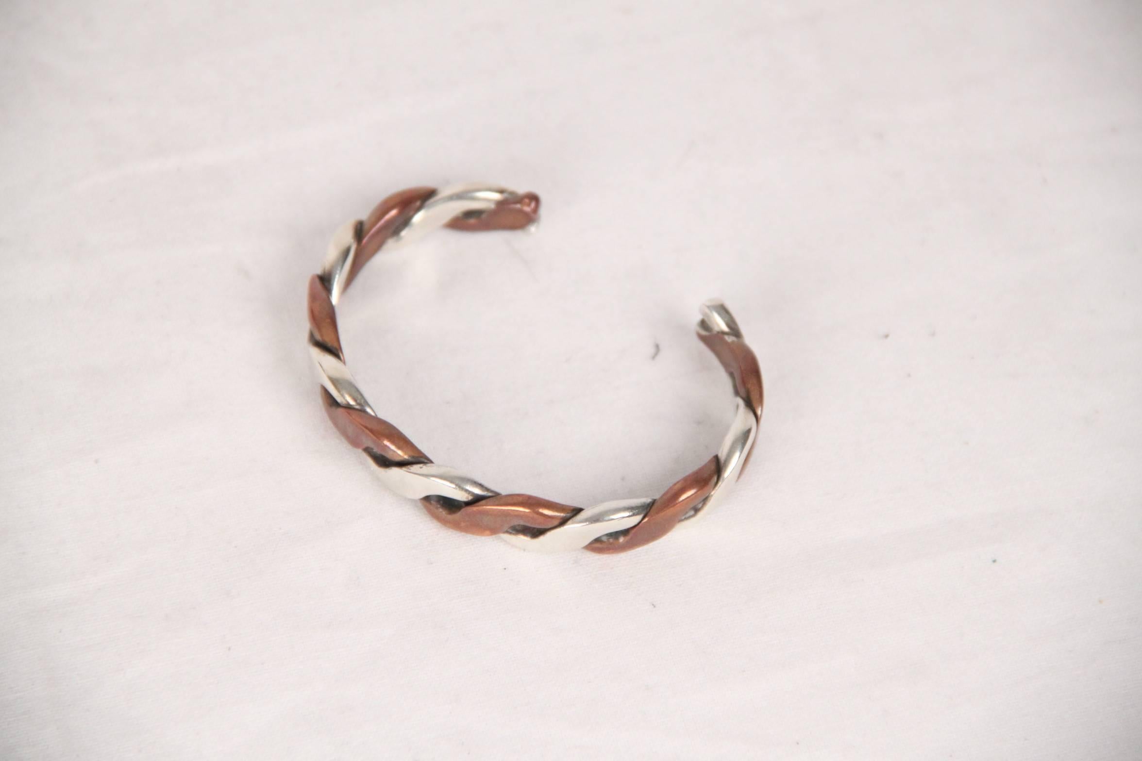 Vintage GUCCI bracelet from the 1970s. Bangle design, it is crafted in copper and sterling silver. 

Logos / Tags: 'GUCCI Boutique' engraved inside the bracelet. The bracelet is marked '925' and other silver mark internally