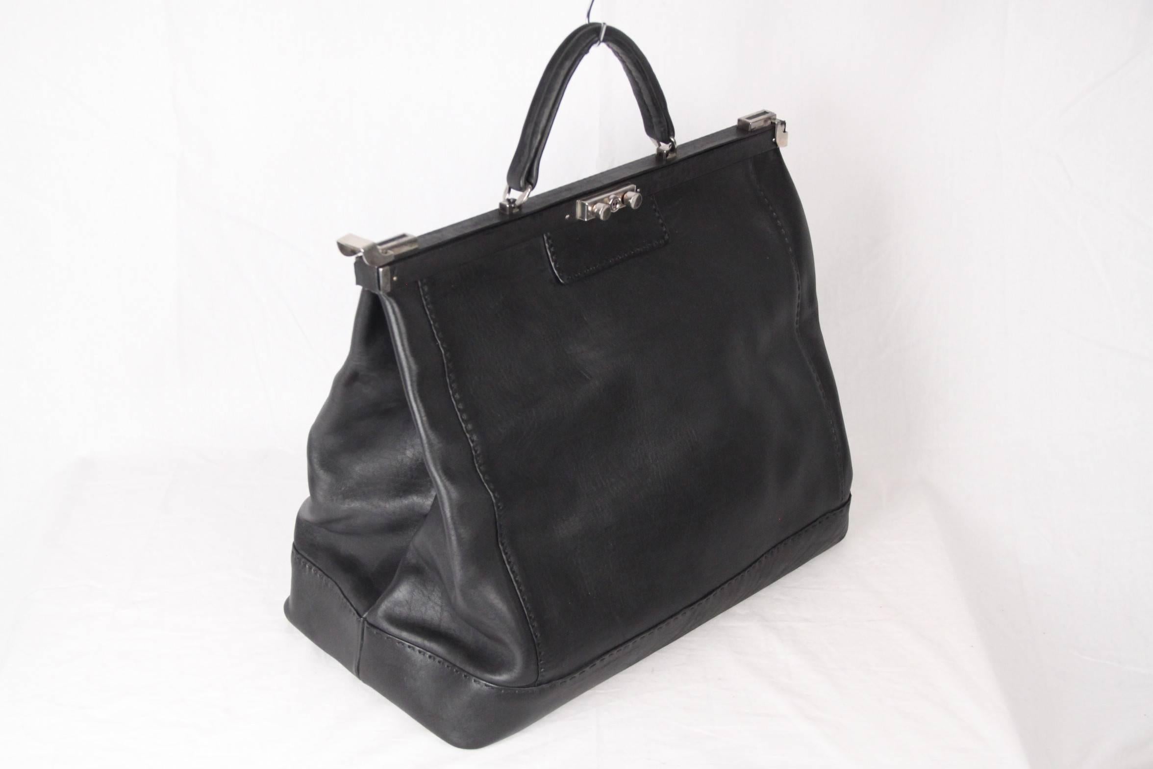 Oversized doctor bag,  weekender, carry on, or overnight tote bag, made in black genuine leather.  Framed top with lock closure on the front and side closures. Protective bottom feet. Inside, the bag has a removable pouch that can be which can also