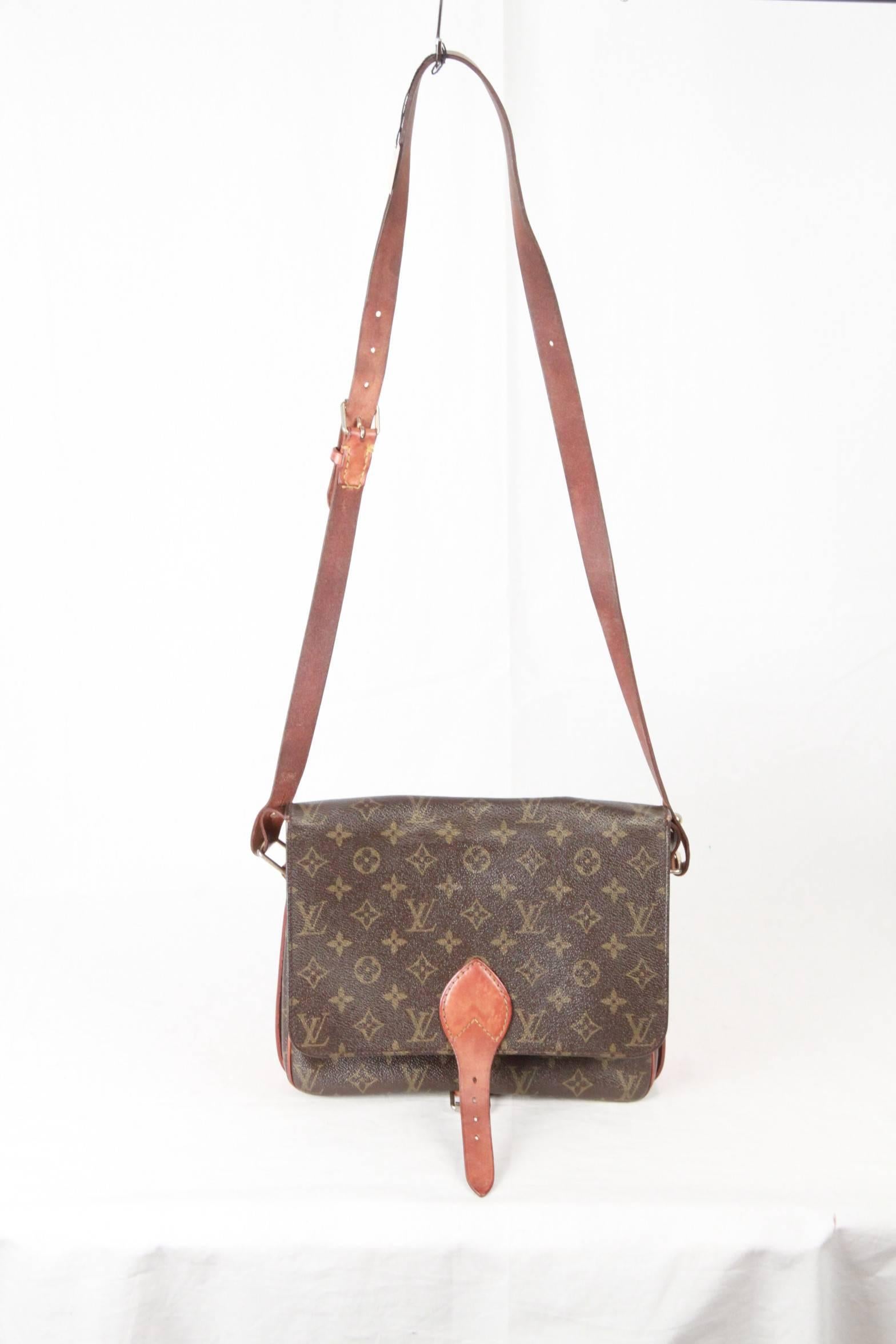 - Louis Vuitton Vintage Monogram Canvas Cartouchiere GM Bag
From 1983
- Brown Monogram Canvas with genuine leather trim
- It features a square shape with a flap top and buckle closure.
- Its interior in cross grain leather
- Divider in the bag