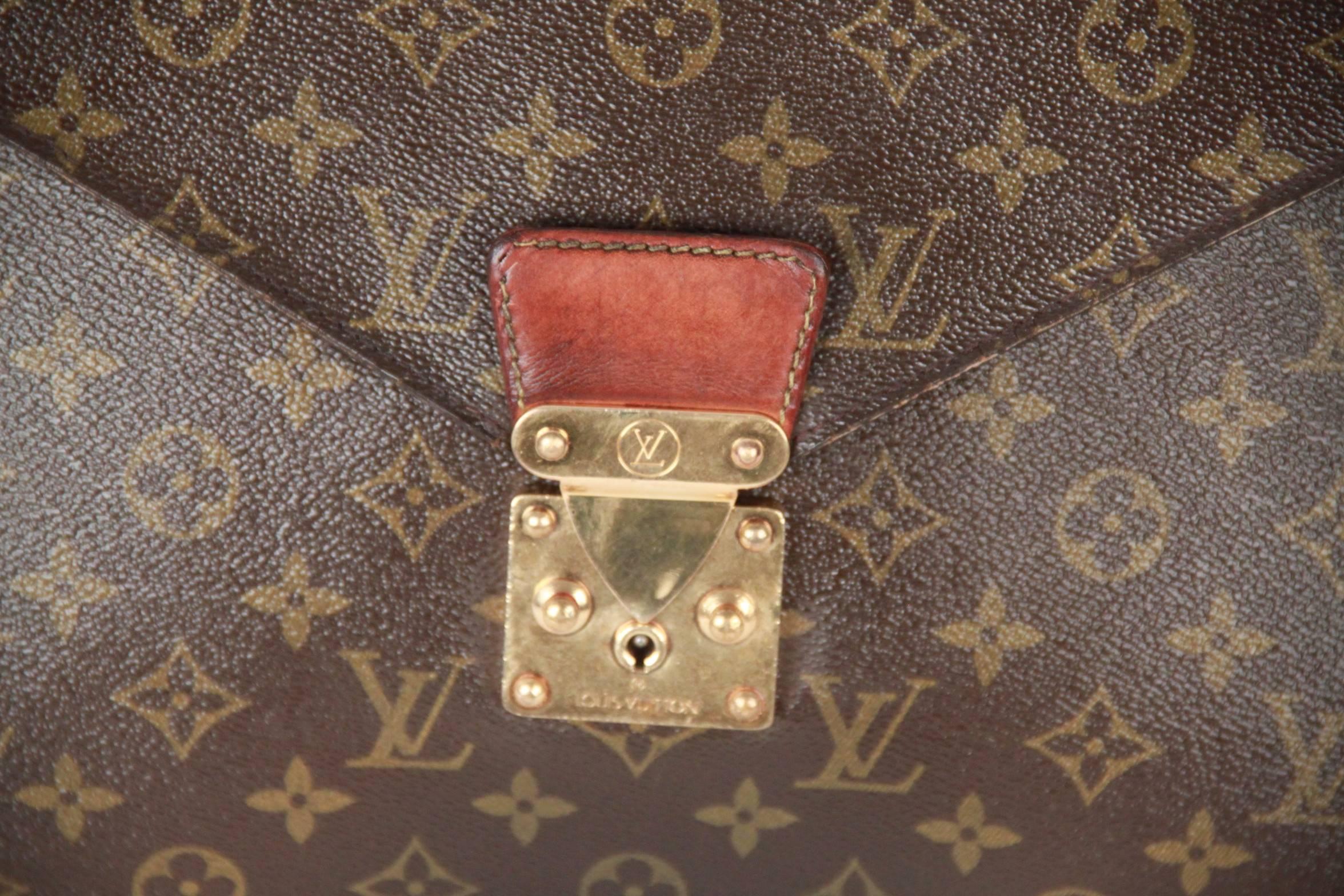 LOUIS VUITTON Monogram SENATEUR Document Holder/Portfolio. The case is a large document holder and is structured of classic Louis Vuitton monogram on canvas. It features a frontal flap with a polished brass s-lock. This opens to a brown cross-grain