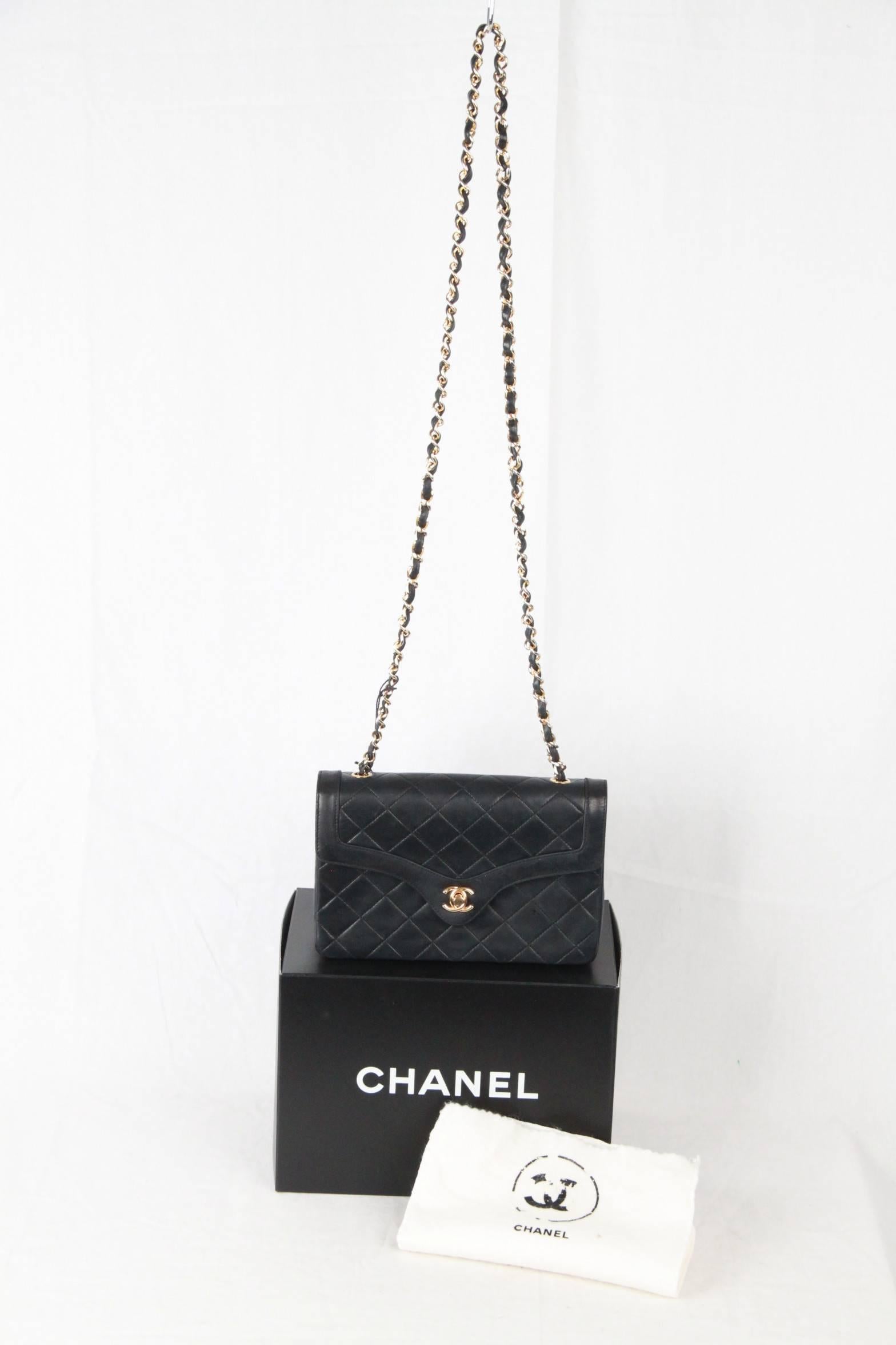 Chanel Vintage Quilted Flap Bag with Smooth Trim and gold hardware from the 1991. Blue leather crossbody bag with the classic chain and leather shoulder strap. Chanel CC turn lock opens the single flap to reveal the bordeaux lambskin-lined interior.