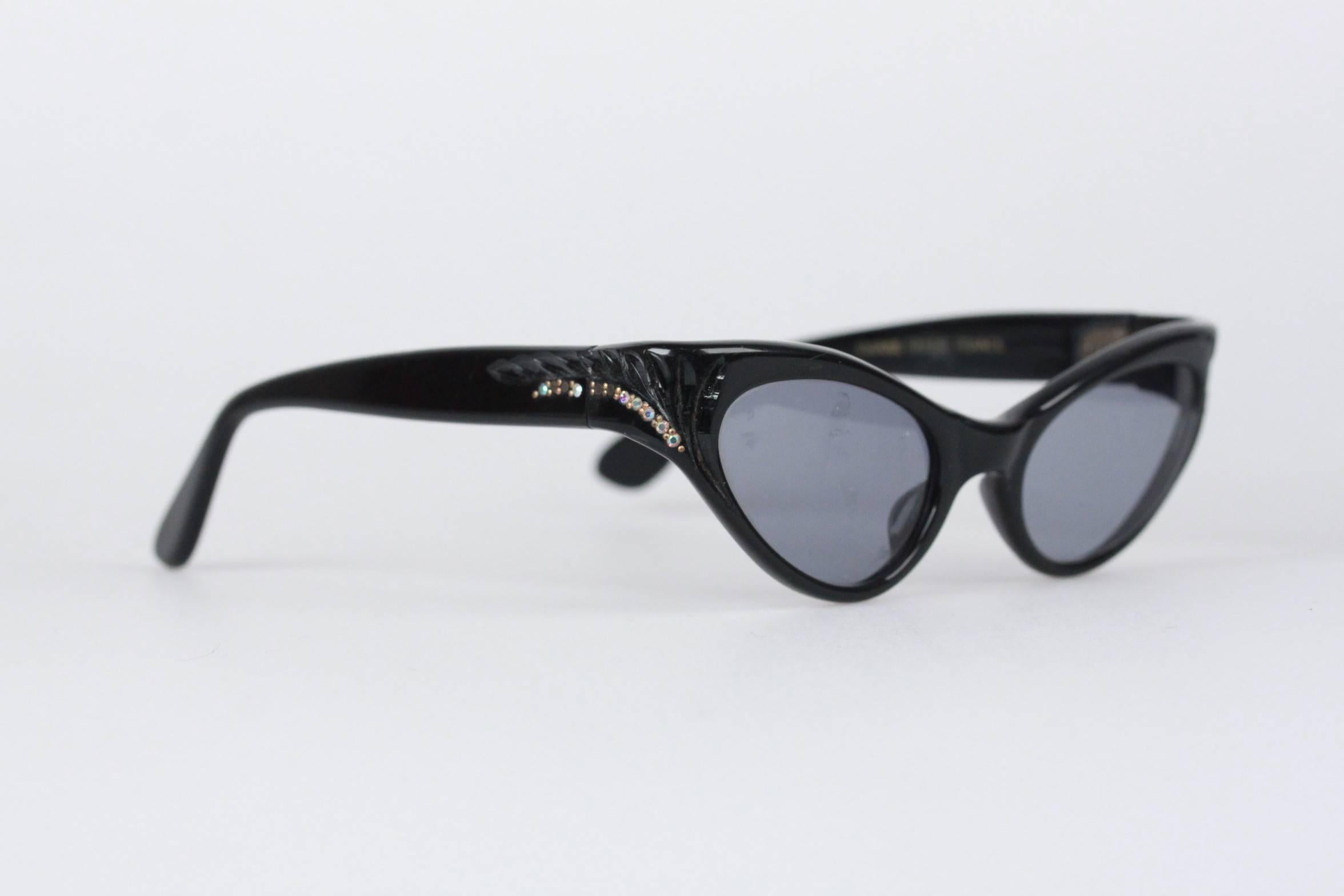 Unique vintage cat-eye sunglasses that are always timeless and always classy. Made with an acetate black based frame with rhinestones and indented detailing on corners, metal hinges and replaced UV protected lenses. Made in France.

Style &