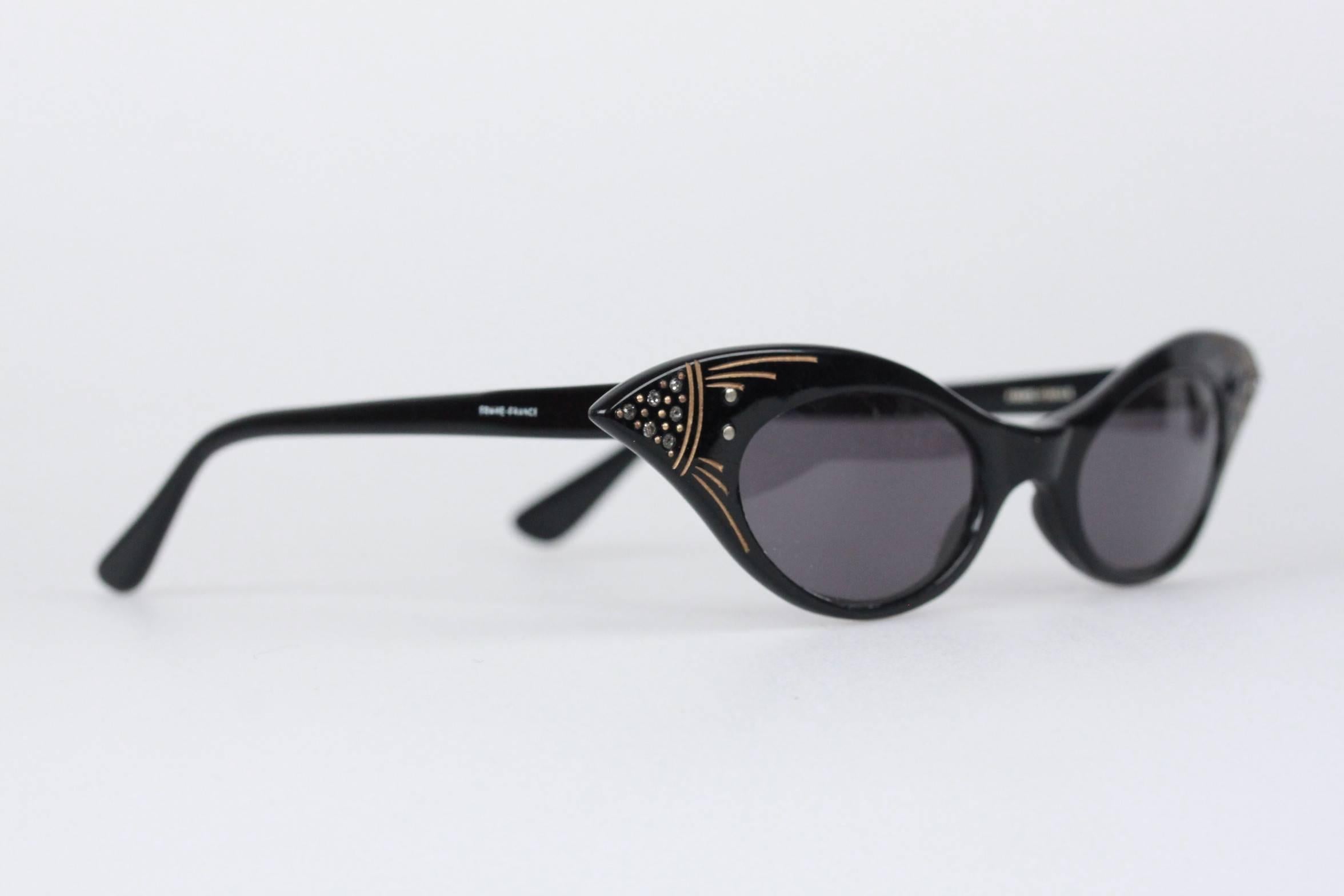 Unique vintage cat-eye sunglasses that are always timeless and always classy. Made with an acetate black based frame  with rhinestones and golden painted indented detailing on corners, metal hinges and replaced UV protected lenses. Made in