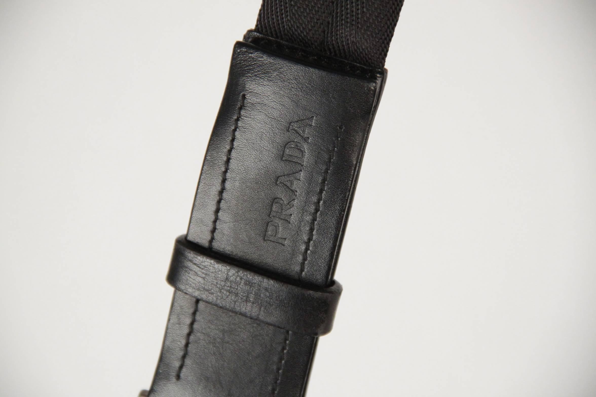 - Prada shoulder bag crafted black neoprene fabric
- 2 front zip pockets
- Upper velcro closure 
- Flat shoulder strap 15 inches -38 cm drop.
- Black PRADA lining
- 1 side zip pocket
- Measurements: 9 x 14 x 3.25 inches - 22,9 x 35,5 x 8,3 cm

Logos