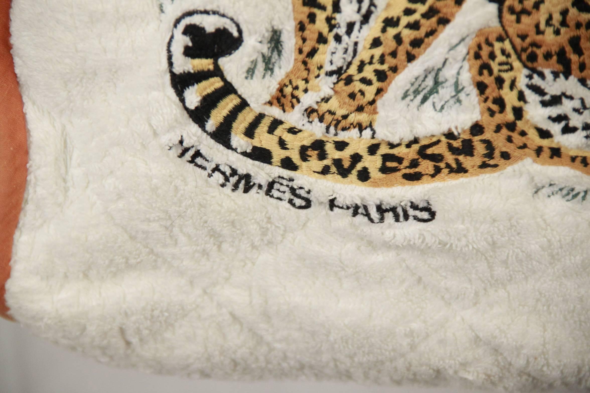 - HERMES beach bag crafted in white quilted terry cloth
- Embroidered tiger design on the front
- Piped yellow edges
- Open top
- cotton lined interior that holds a bottom zippered storage compartment
- This piece is in excellent condition. No